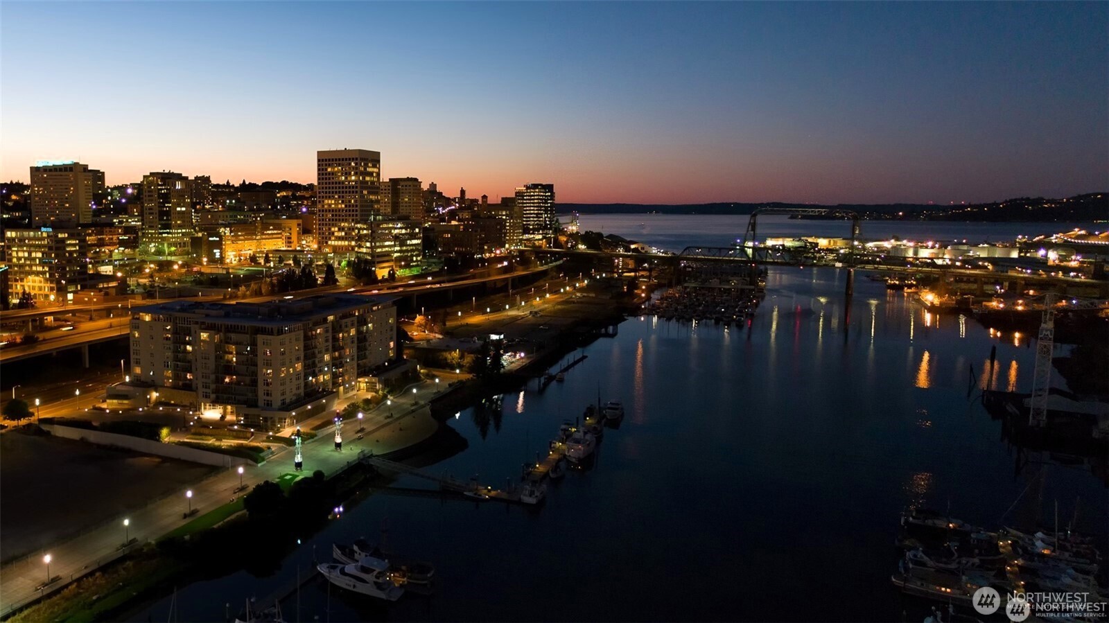 The Thea Foss Waterway at twilight, with The Esplanade shown on the left.