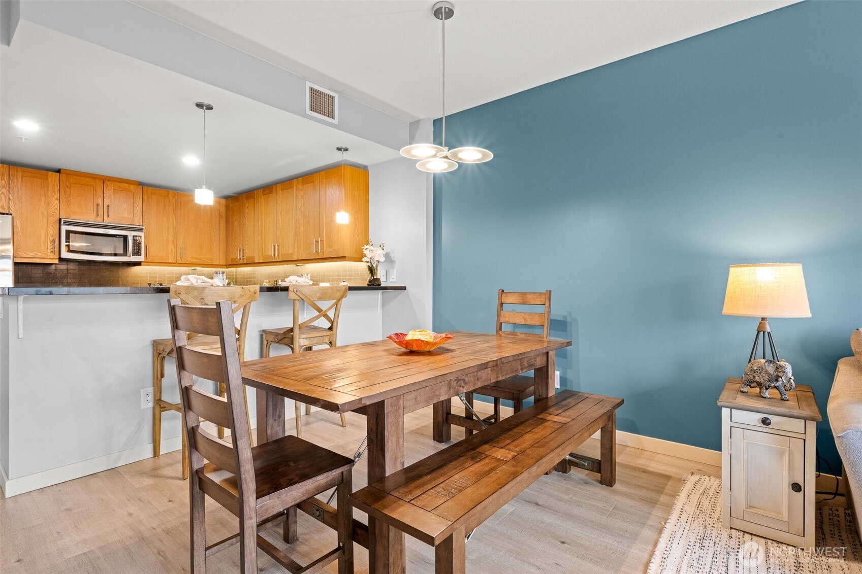 You can see there is sufficient space for a dining room table in addition to the breakfast bar seating.