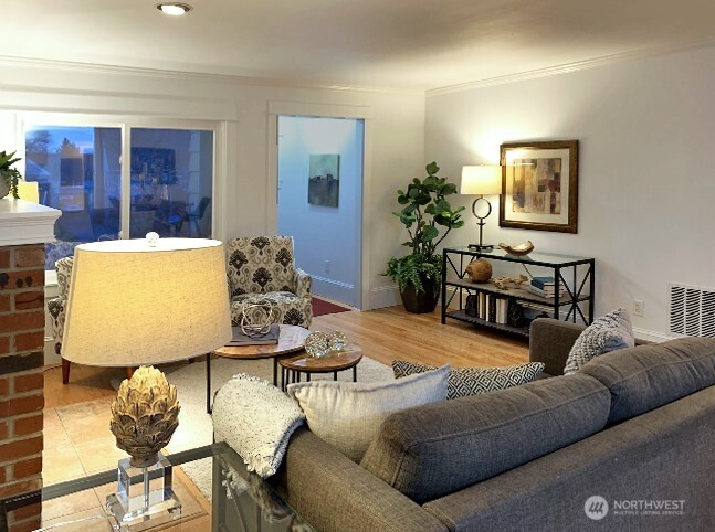 A view of the living room looking towards the entry way. The windows have a reflective film on the windows, giving you more privacy in the living room.