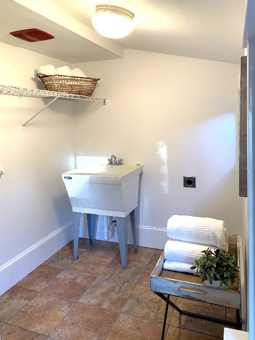 The laundry area is just off the kitchen. The sink is handy for your hand washables and when you come inside from the back door and want to wash your hands.