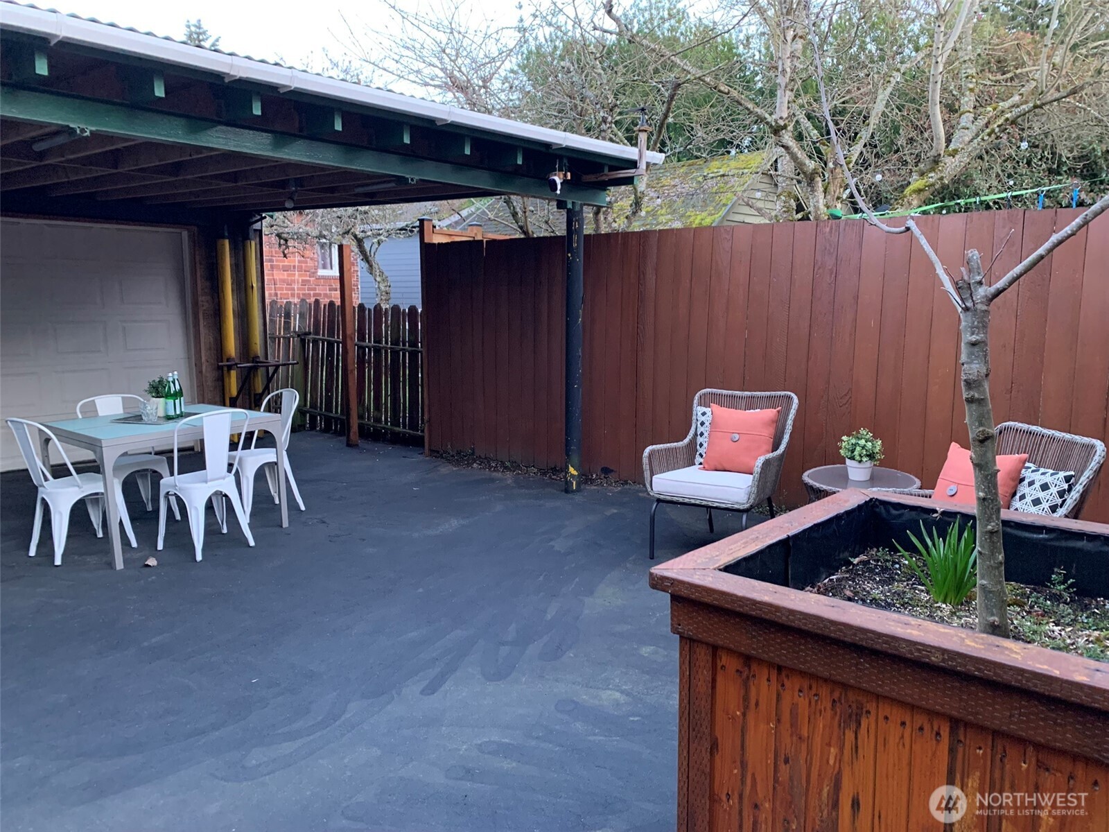 About 1/2 the yard is covered for year around enjoyment. Adding shade in the summer and keeping you dry when raining. The garage can be opened to the back yard. A bonus when working on all sorts of projects, or more space for entertaining.