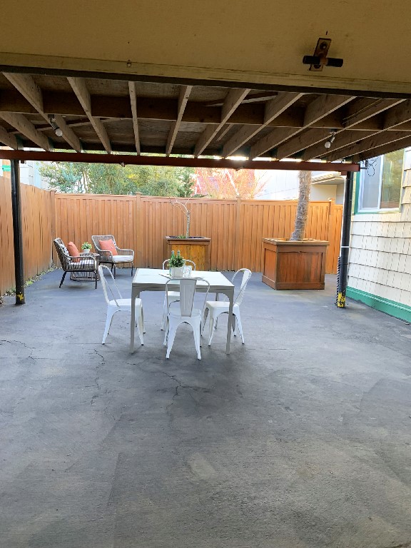 The back patio space. Think of all the time you will save with only the front yard needing to be tended.