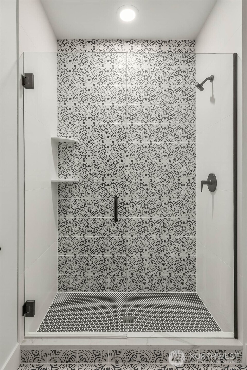 Designer Selected tiles accent stunning mudset shower with frameless glass enclosure