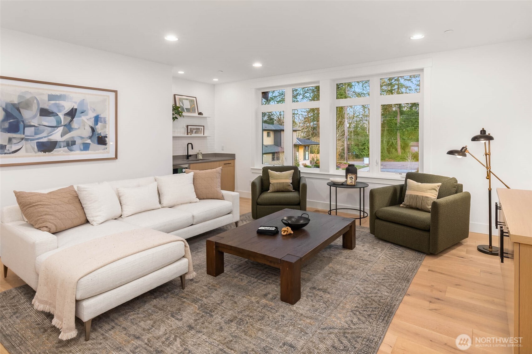 Second floor rec room with hardwood flooring and wet bar