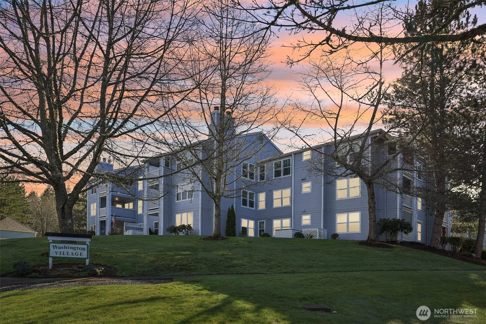 Located on a grassy hillside with lovely landscaping around building.