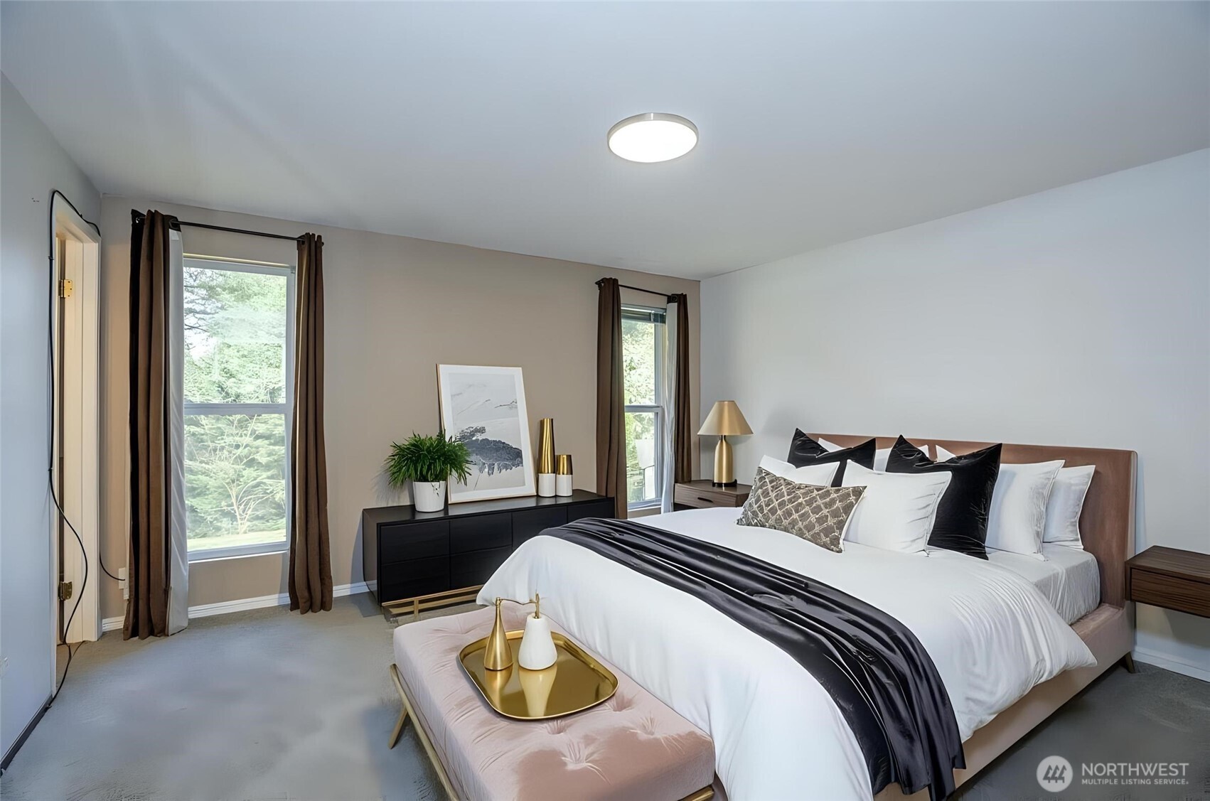 Primary suite featuring new carpet and impressive floor-to-ceiling windows that fill the room with natural light - virtually staged for inspiration.