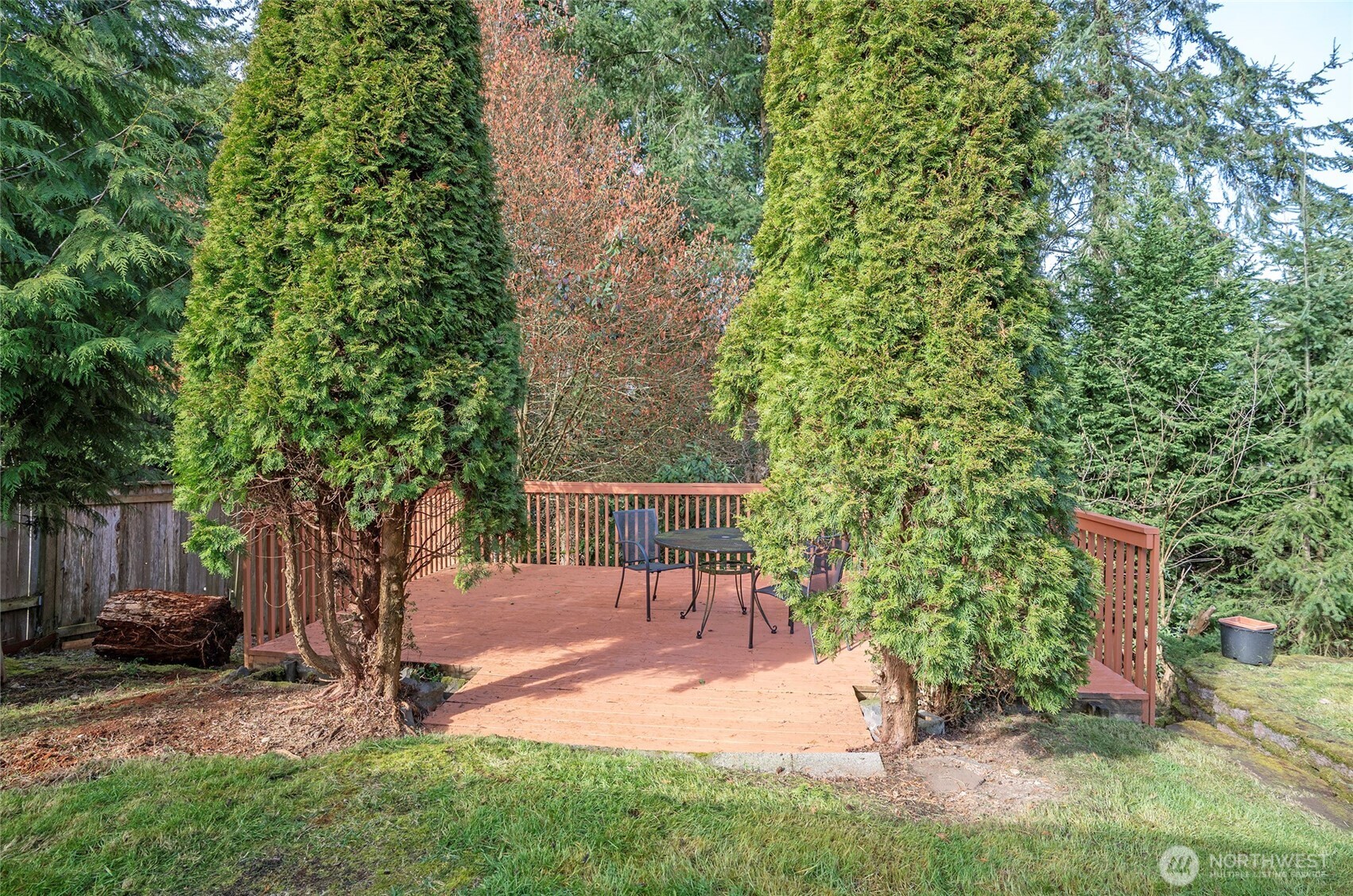 The expansive backyard deck backs directly to the Olympic View Park trail system—an ideal spot for entertaining or unwinding in the privacy of your fully fenced yard.