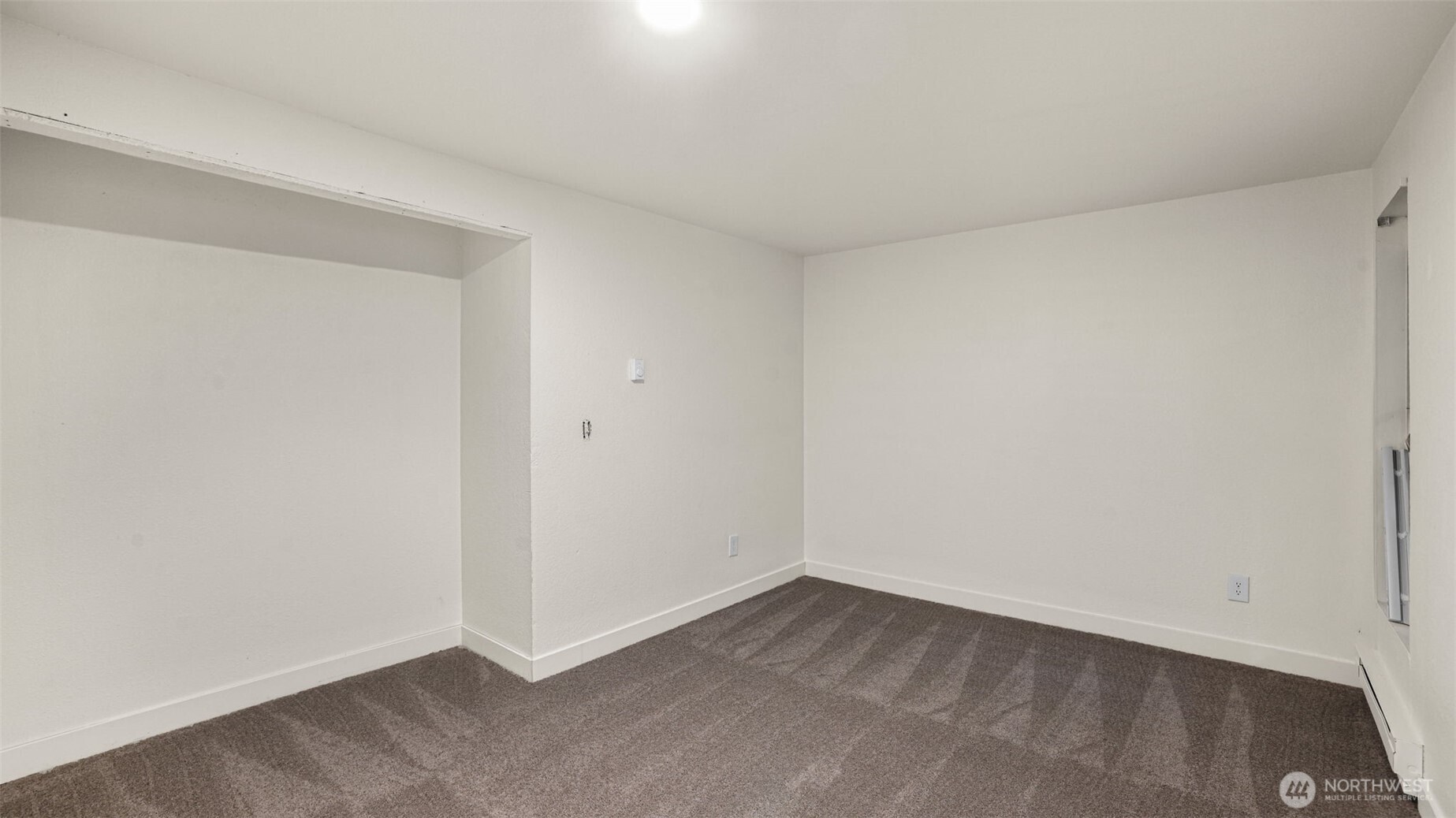 Another sizable guest bedroom with open closet.