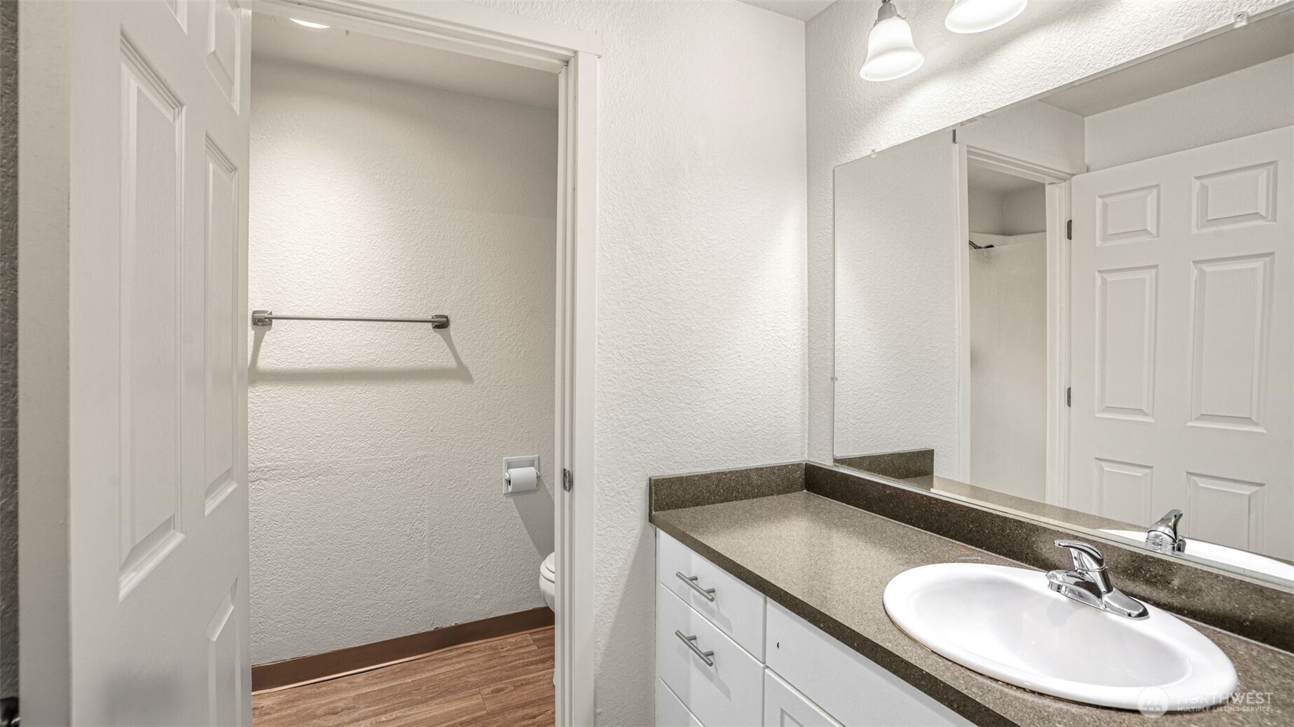 Updated vanity offers an abundance of storage and is separated from the water closet where you'll find the walk-in shower.