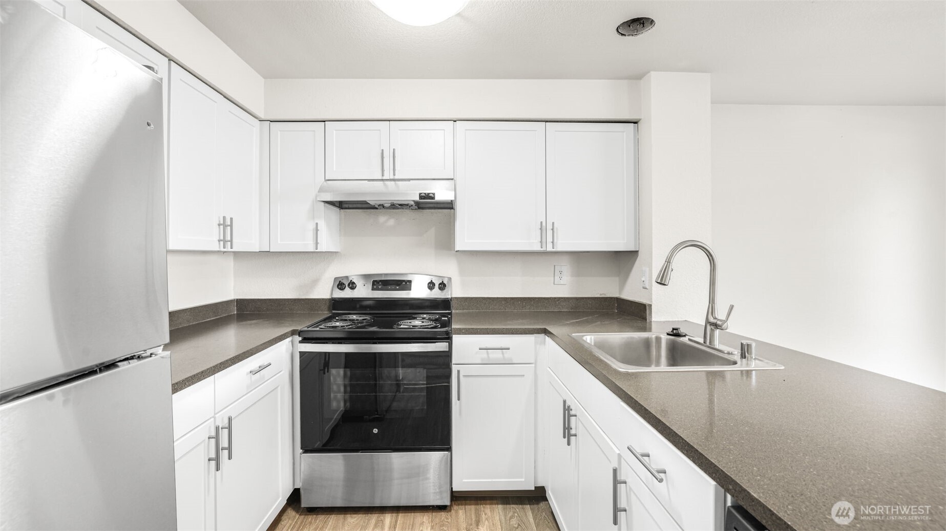 White shaker cabinetry, sleek countertops, plenty of storage & all appliances stay.