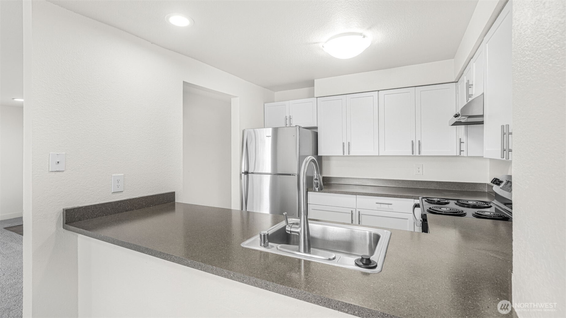 Another angle of this galley style kitchen showcases the flow as well as the light & bright feel.