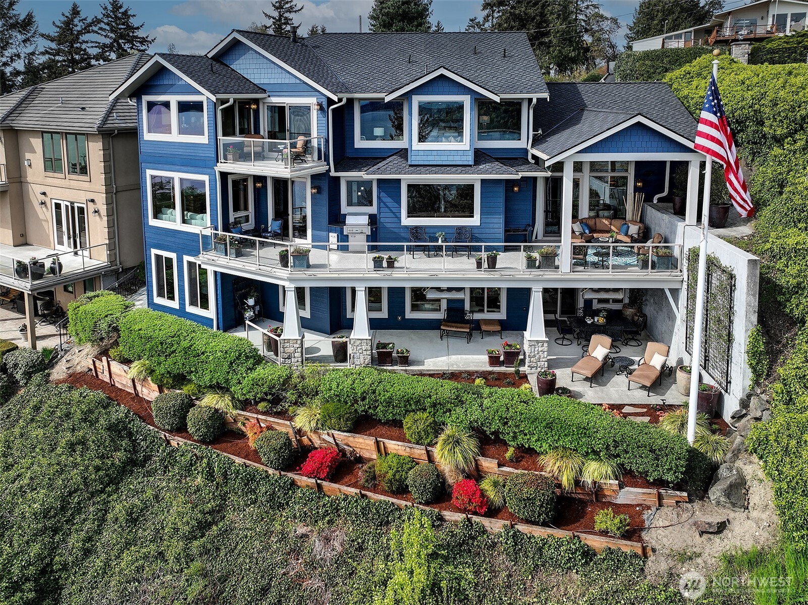 Drone from Southside of home. Landscaped for low maintenance. Wonderful three stories of a masterpiece.
