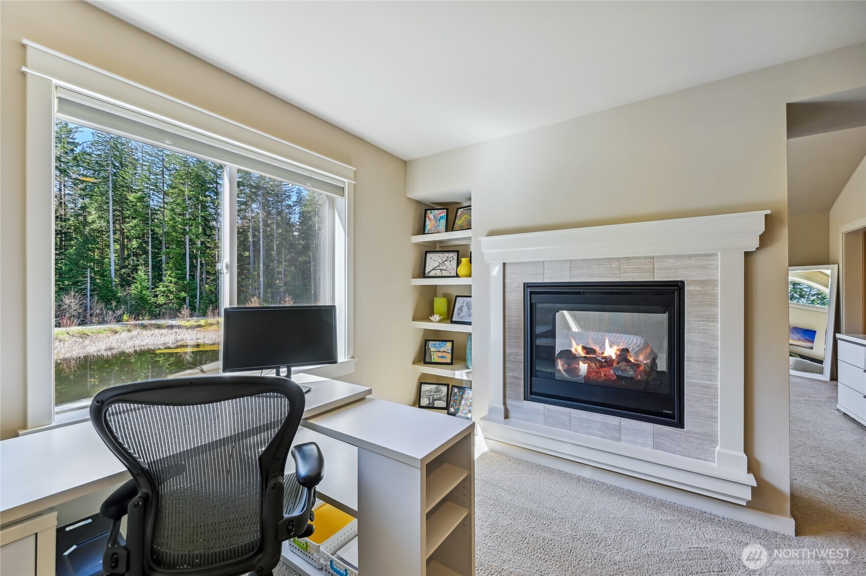 What a great work space or sitting area in the primary suite with beautiful views and a gas fireplace.