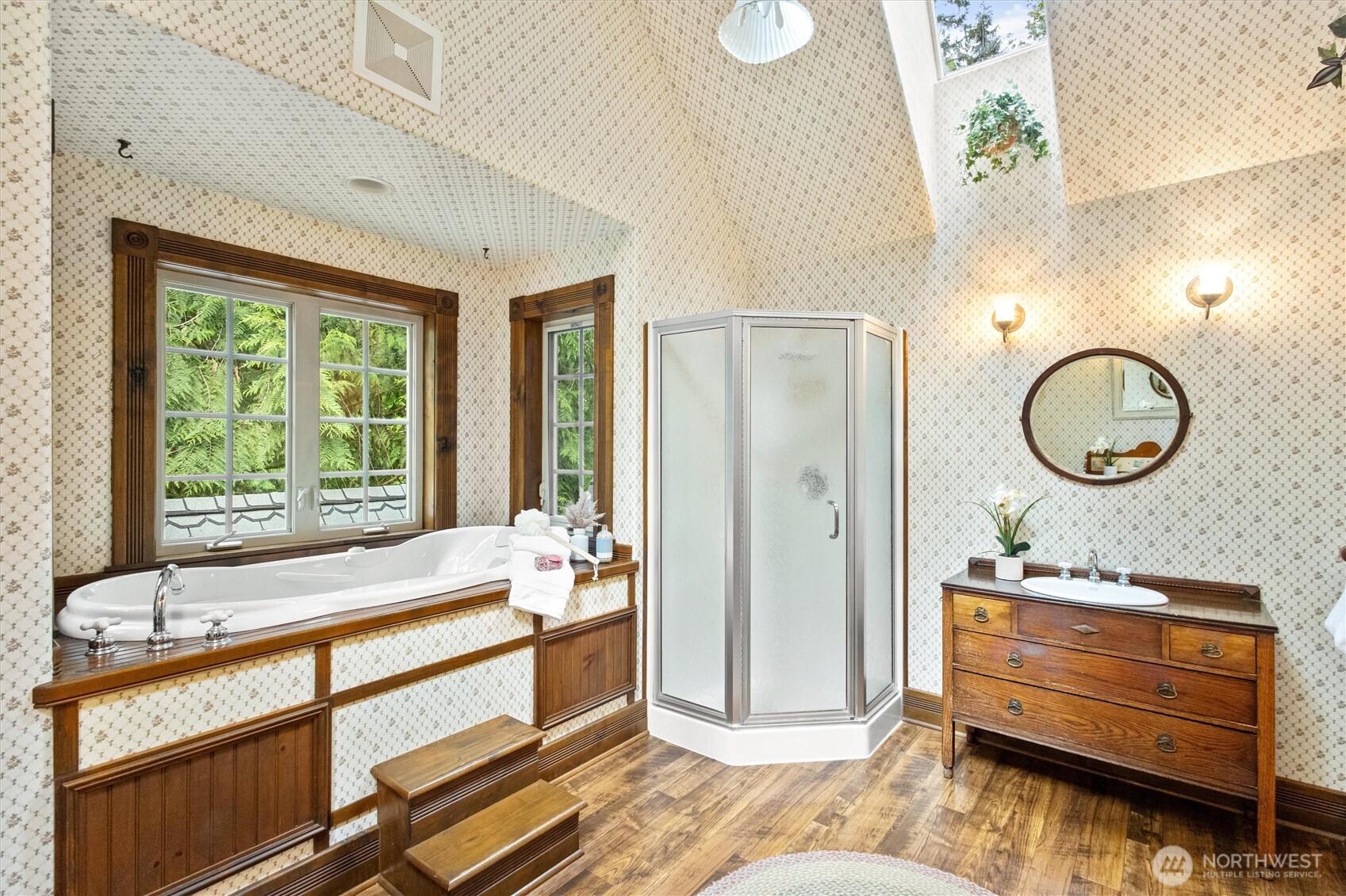 Primary en-suite features large, jetted soaking tub, skylights and His & Hers vanities.