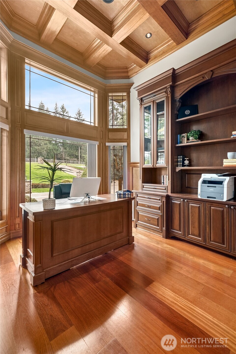 With a gorgeous timber waffle coffered ceiling, custom built-in cabinetry, and a tranquil view of the front water feature, this space exudes success.