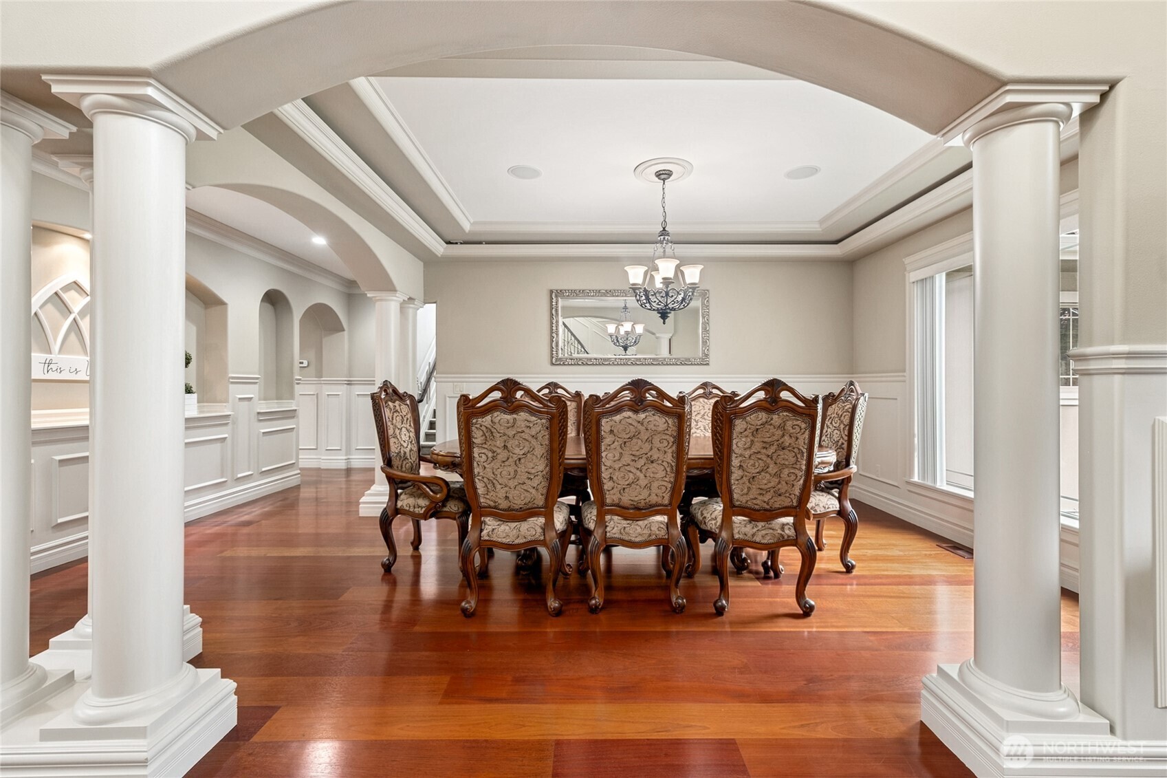 Dining in style! This formal dining room features a lovely coffered ceiling and elegant pillars, setting the stage for unforgettable meals and moments.