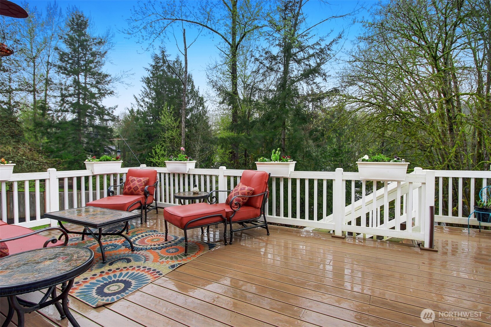 Expansive deck that leads down to large fenced yard.