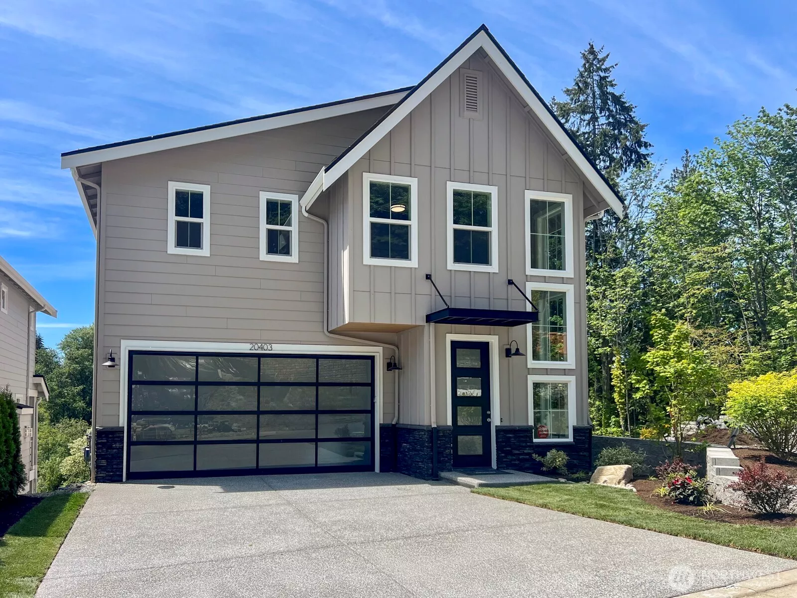 East facing. Listed home to the left of model home in photo & same floor plan.