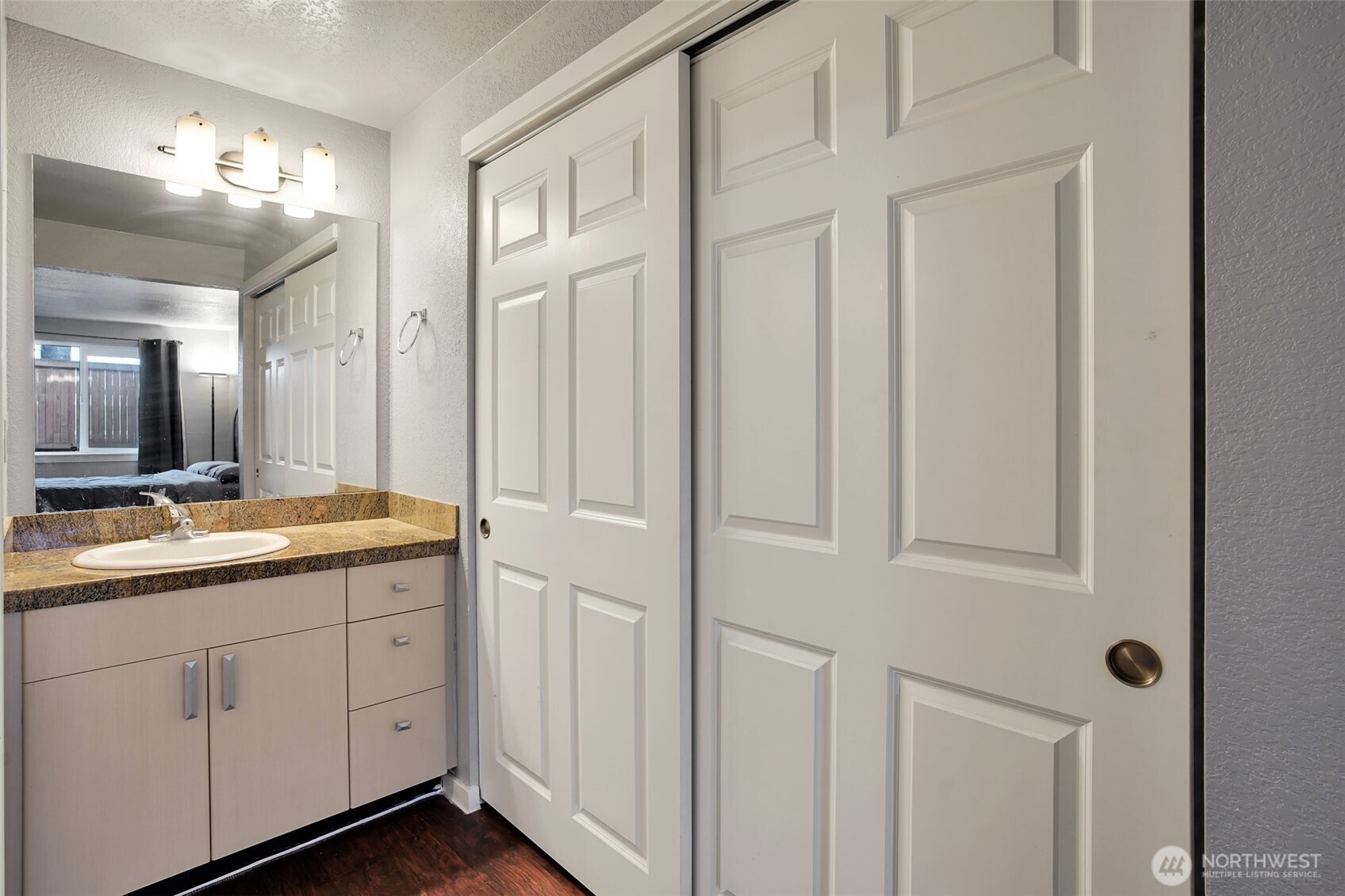 Primary bedroom features a convenient vanity area and 2 closets.