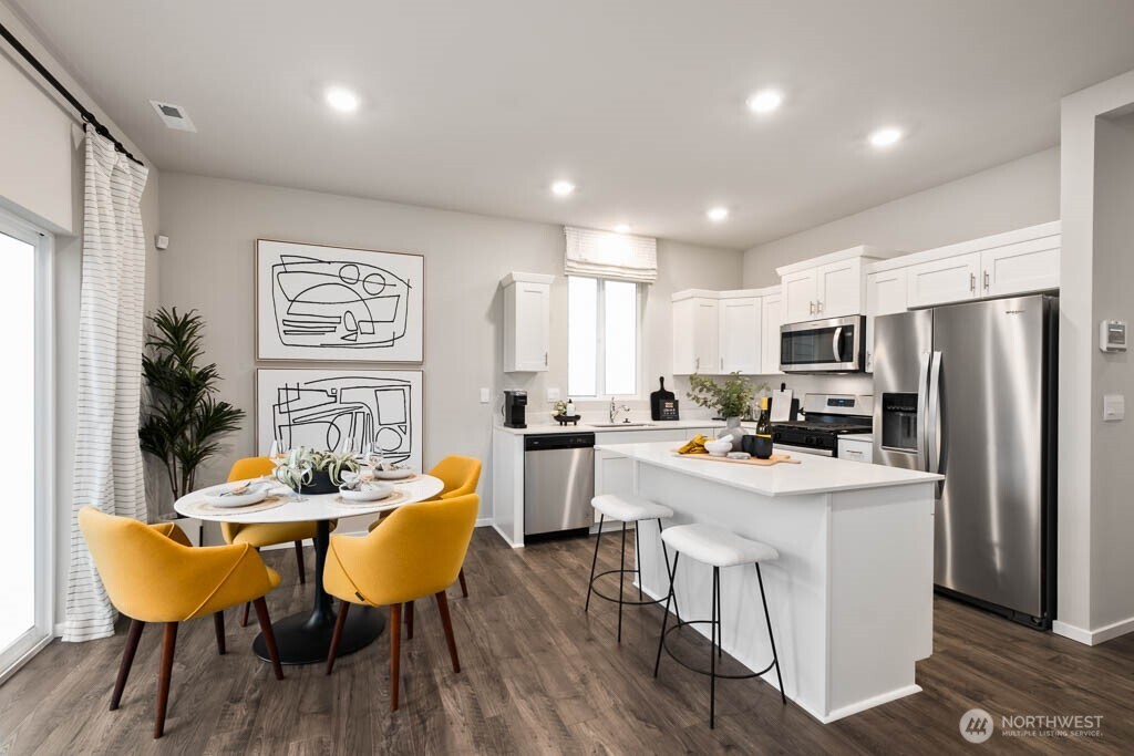 Beautiful kitchen with island and dining space. Colors and options will vary. Photos from Model Home on 31. Homesite 84 is a mirror image.