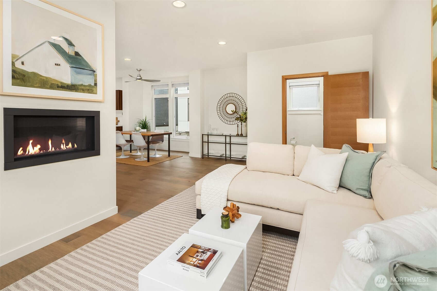 A view of the living room facing the dining area and 1/2 bath.
