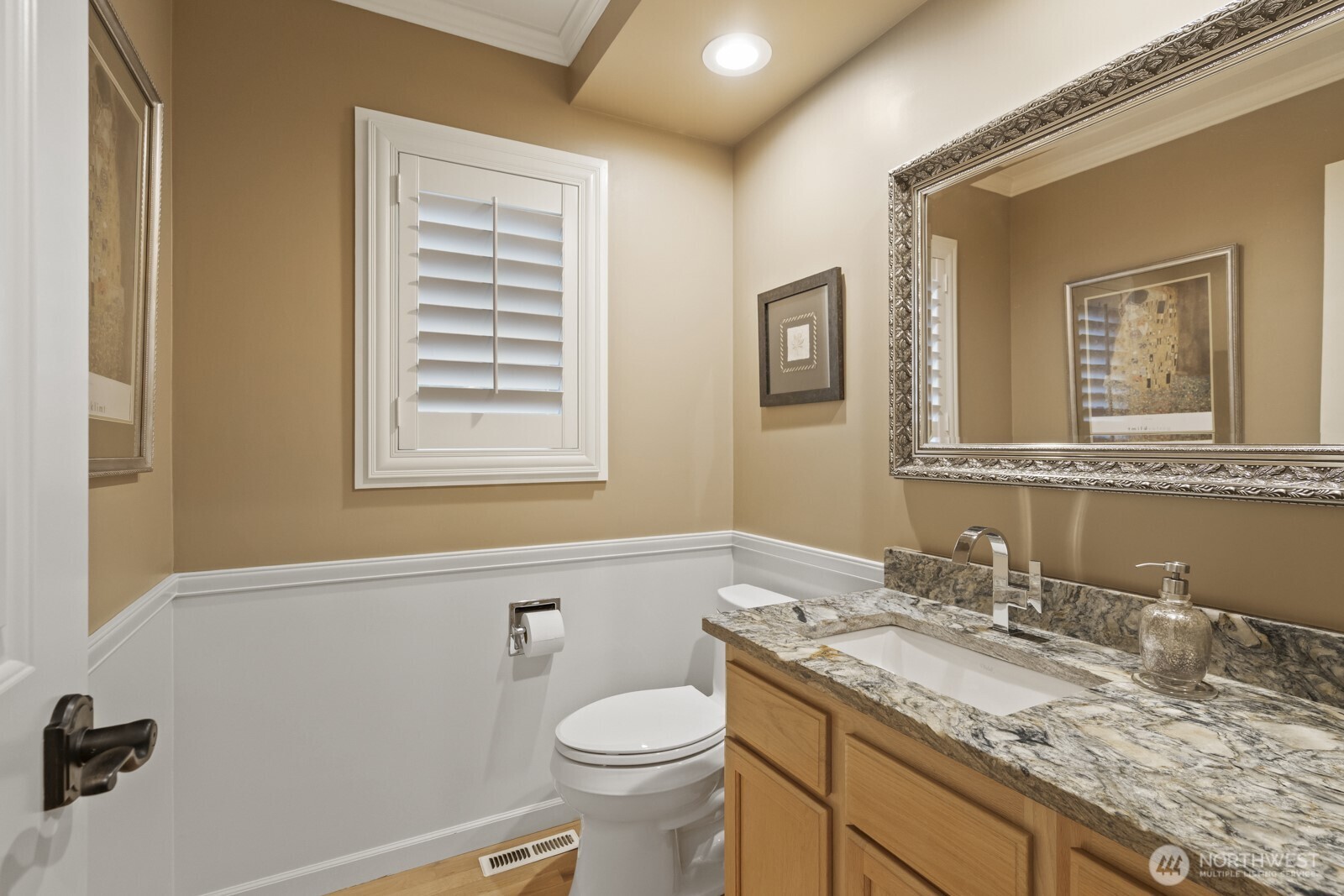 Powder room on main floor with beautiful granite countetop