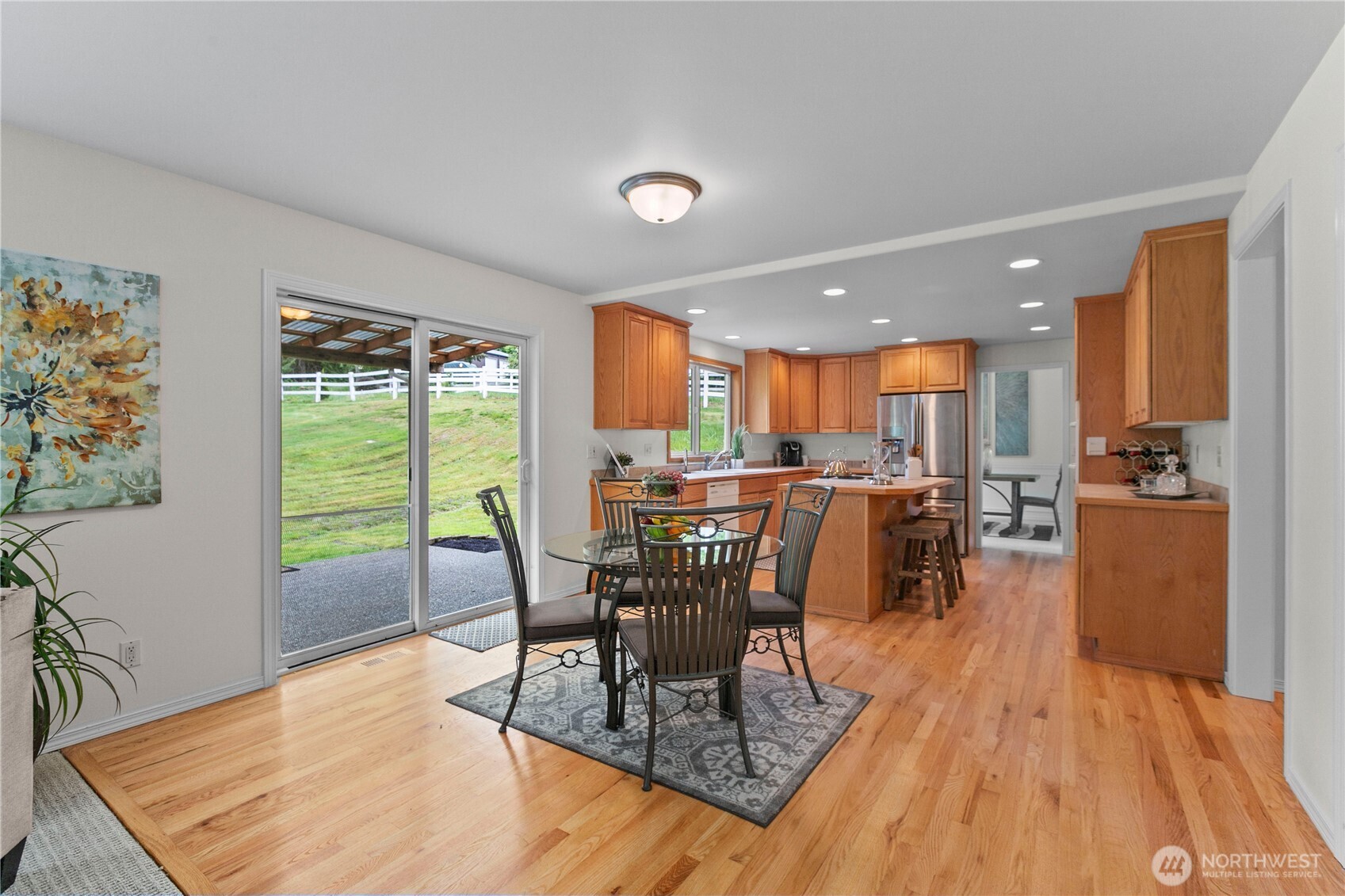 Casual dining area in kitchen/great room with sliders to covered patio.
