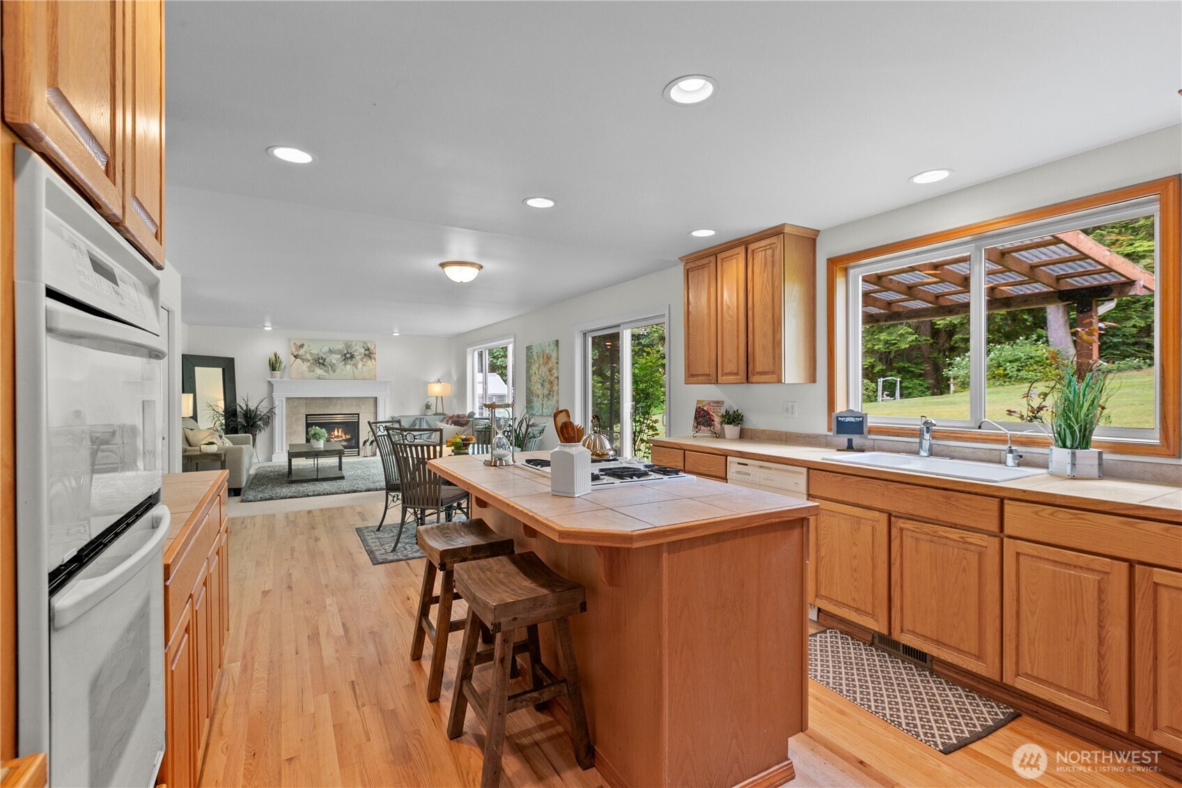 Kitchen viewed from dining room. Great room/family room in background.