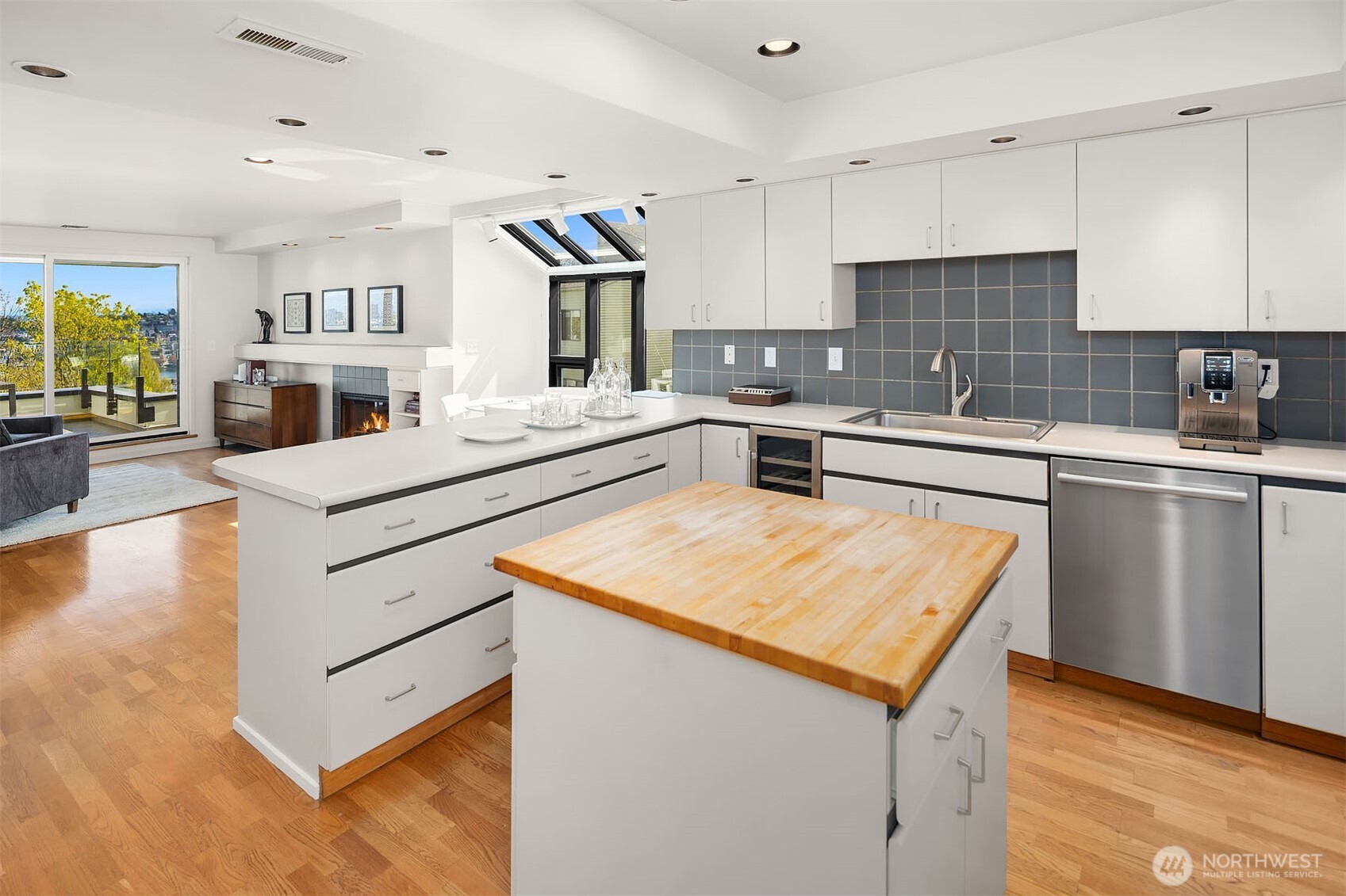 Butcher block countertops and a built-in wine fridge enhance the charm and functionality of this beautiful kitchen.