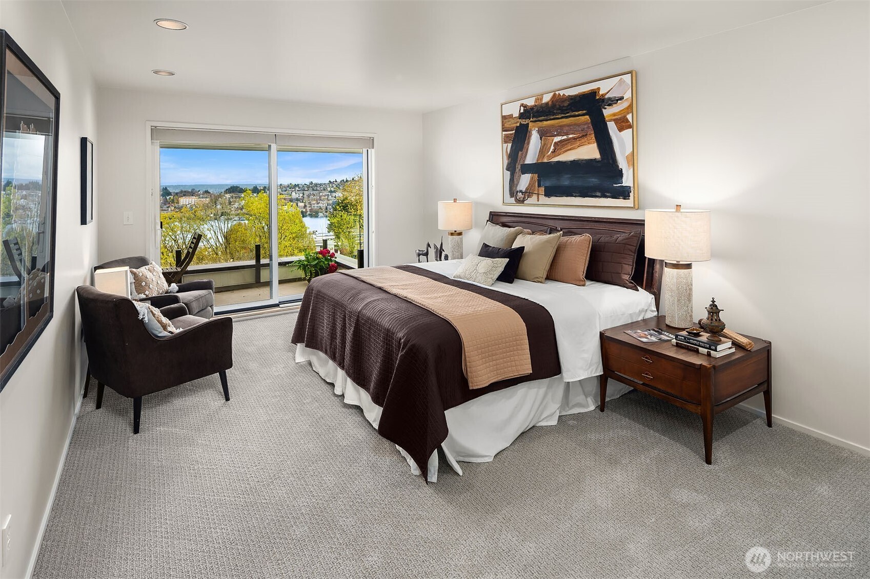 Primary bedroom featuring sliding door access to the deck, ample closet space, and built-in cabinets.