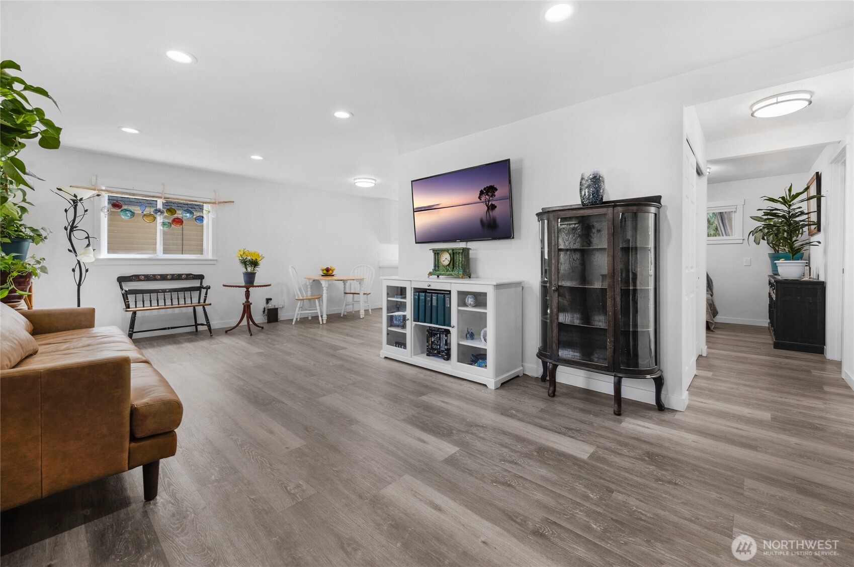 Spacious living room with fresh paint, vinyl windows, LVP floors and Big Screen TV included
