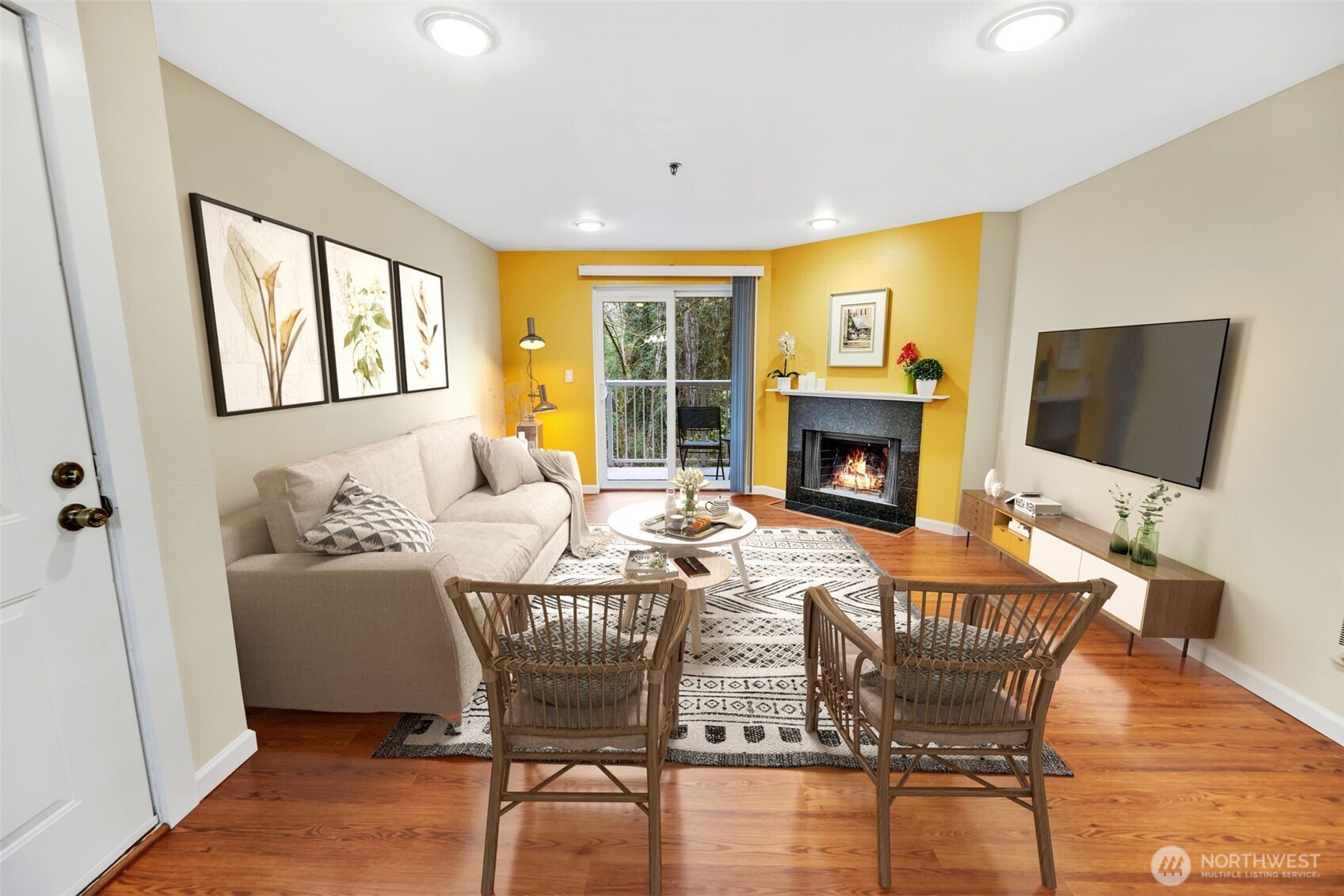 Another view of the living room, modern fireplace and mantle, and can lighting. The patio doors lead to your own private deck overlooking a beautiful wooded greenbelt!