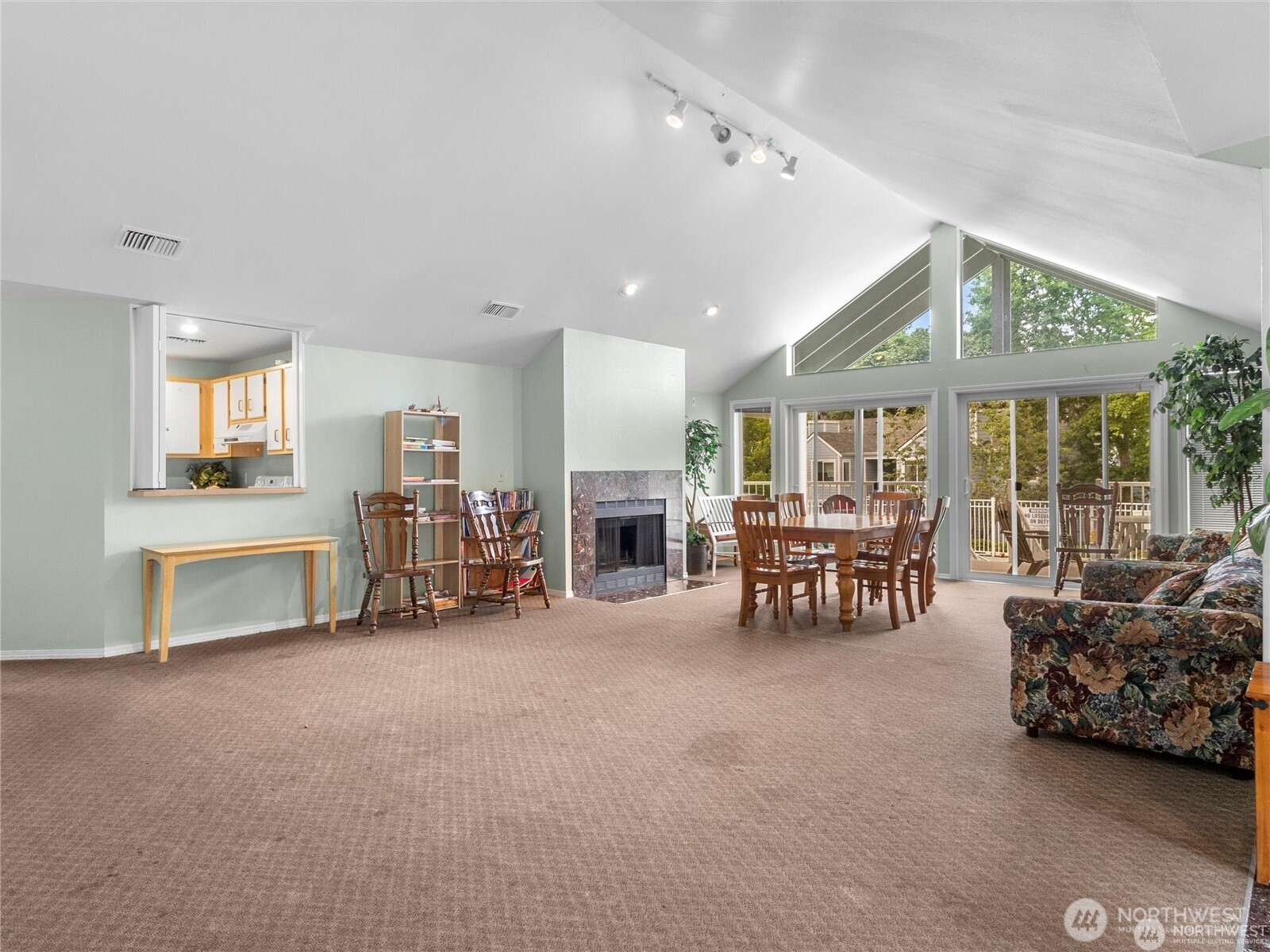 Another view of the community clubhouse towards the kitchen and fireplace.