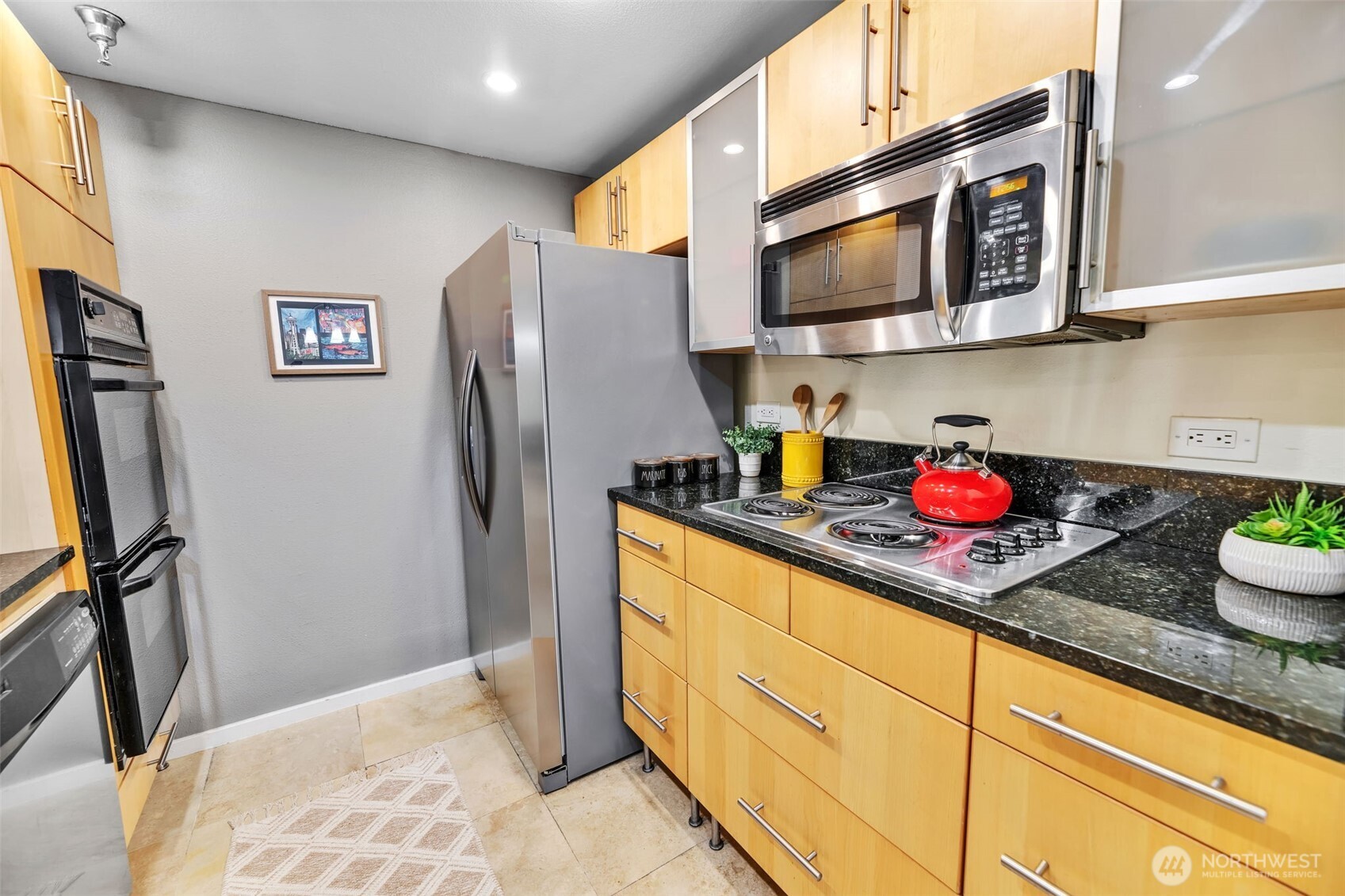 The kitchen also has a brand new refrigerator, recently replaced microwave, stove top range, and cool frosted glass cabinets.