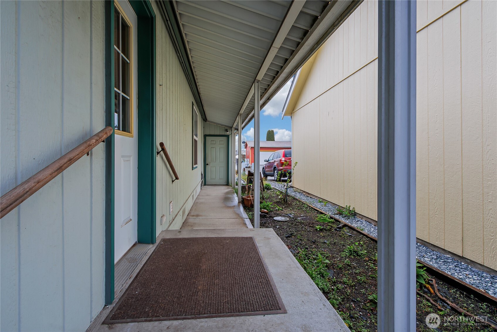 This is the covered walkway outside of the utility room to the garage. You never have to carry your groceries in the rain here. Pull into the garage and exit covered to the house!