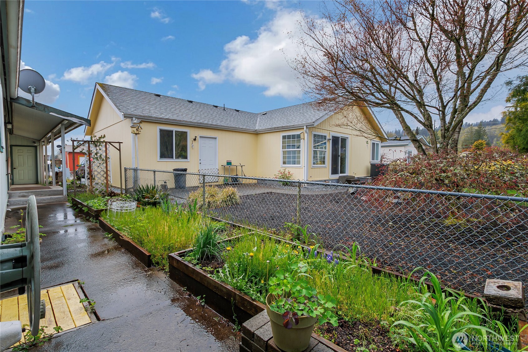 These raised garden beds are down the same side of the house as the covered walkway and it leads around the back corner to the patio as well.