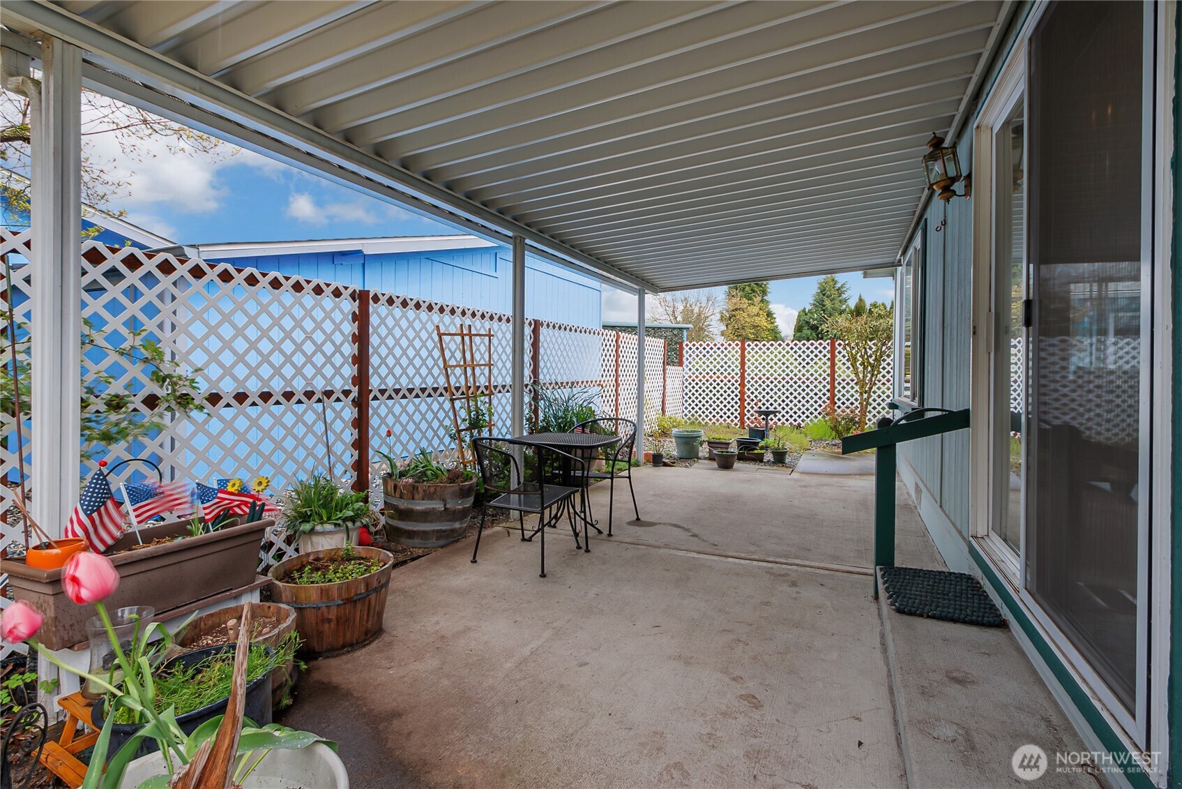 This is the wonderful large covered patio off of the dining area. The pretty lattice work was recently added for appeal and a little more privacy.