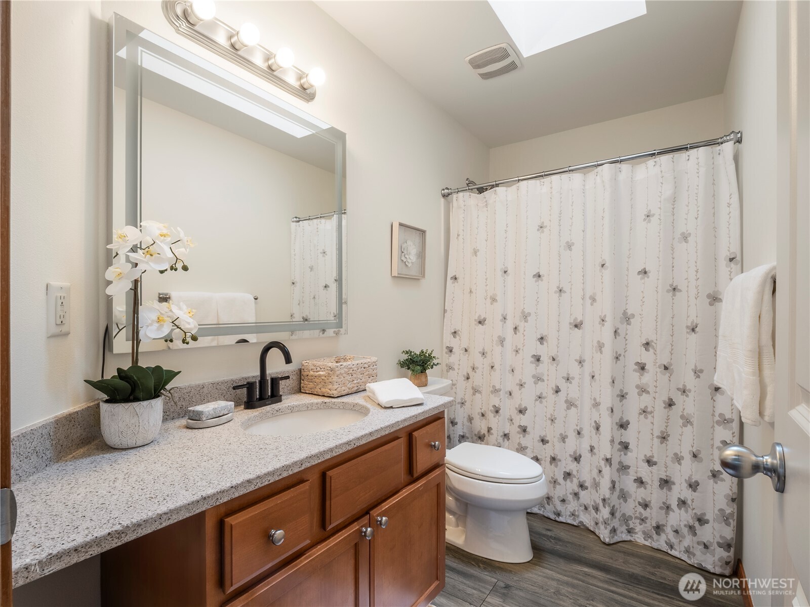 Hall bath with granite counter top, and tub/shower.