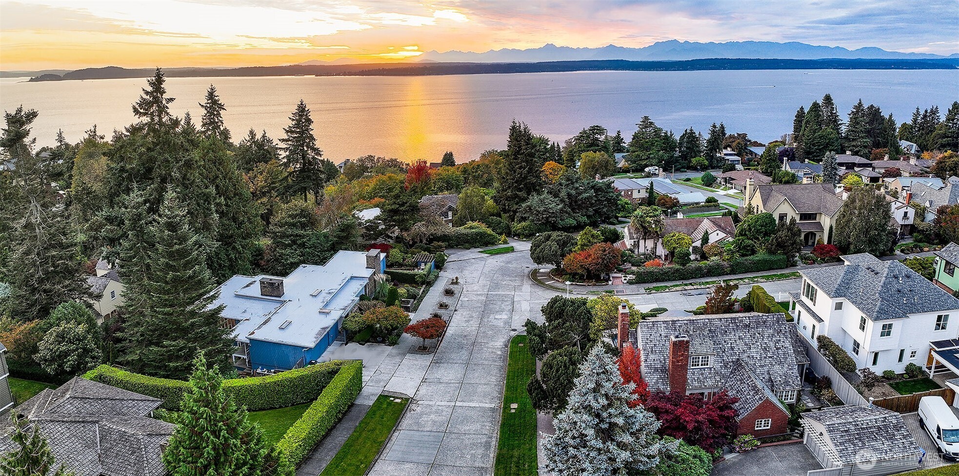 Sweeping east toward the city, this aerial reveals 4221 W Armour’s rare perspective: nestled within Magnolia’s verdant hillside, with the Seattle skyline, Queen Anne ridge, and Cascade Range in layered succession beyond. At sunrise, the home catches the first light of day—an urban sanctuary positioned perfectly between nature and metropolis.
