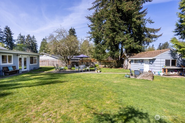 Spacious back yard with ample garden space and fruit trees.