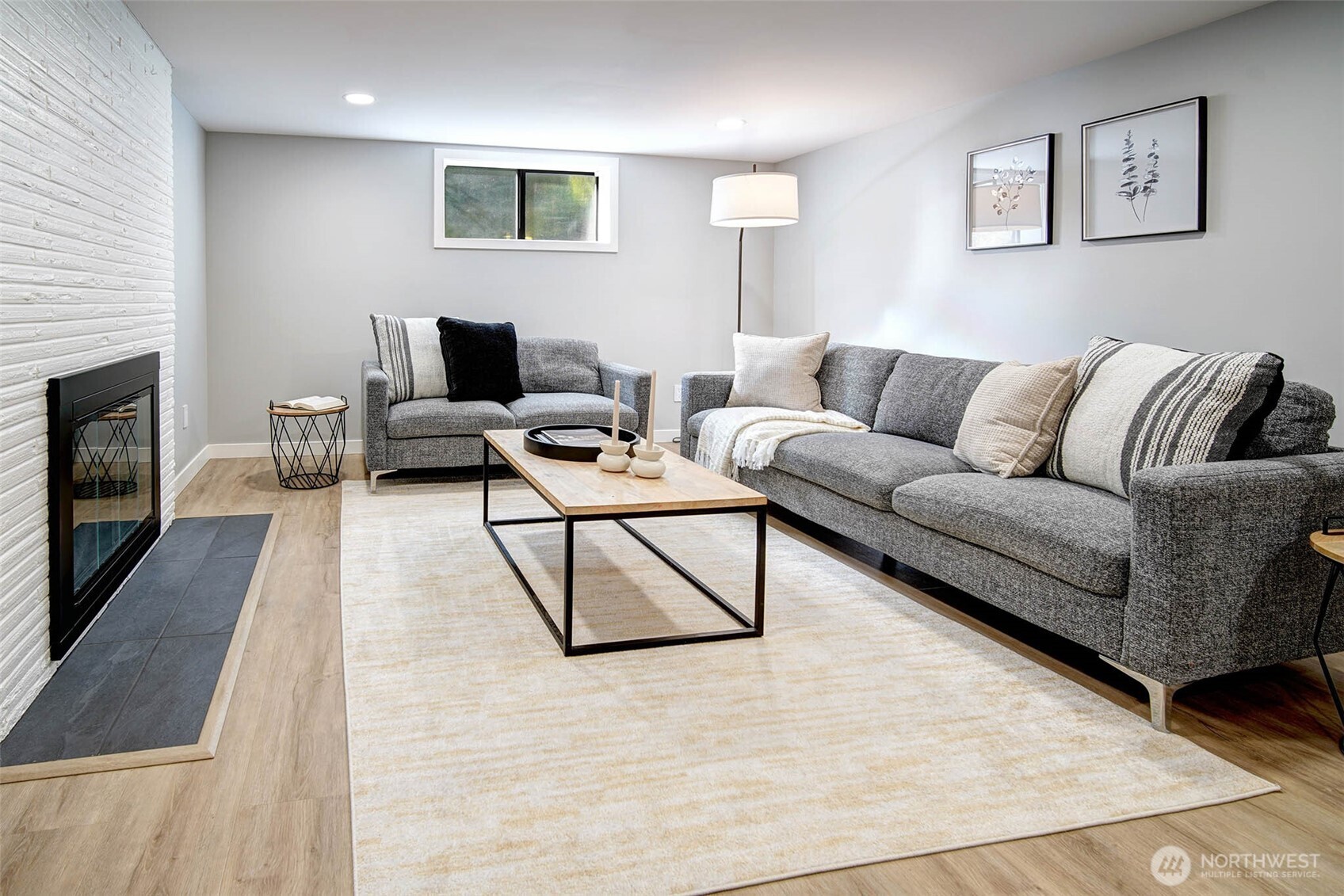 Lower level Family Room. Also with a cozy fireplace & newer flooring.