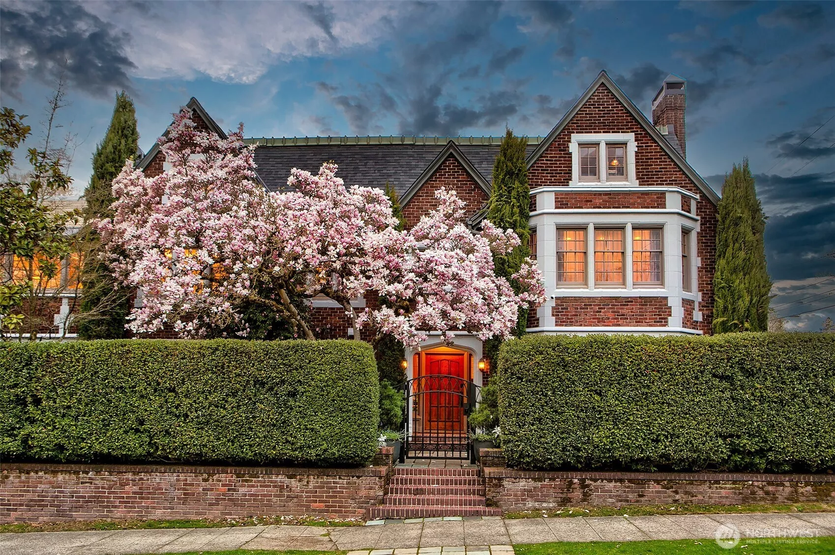 Enshrined behind a sculpted hedge and beneath the bloom of a mature magnolia, the Bullitt Mansion rises with storybook grandeur at the corner of Federal and Galer. Its 1919 Tudor Revival architecture—reimagined in 2023—sets the stage for a home where legacy and luxury entwine.