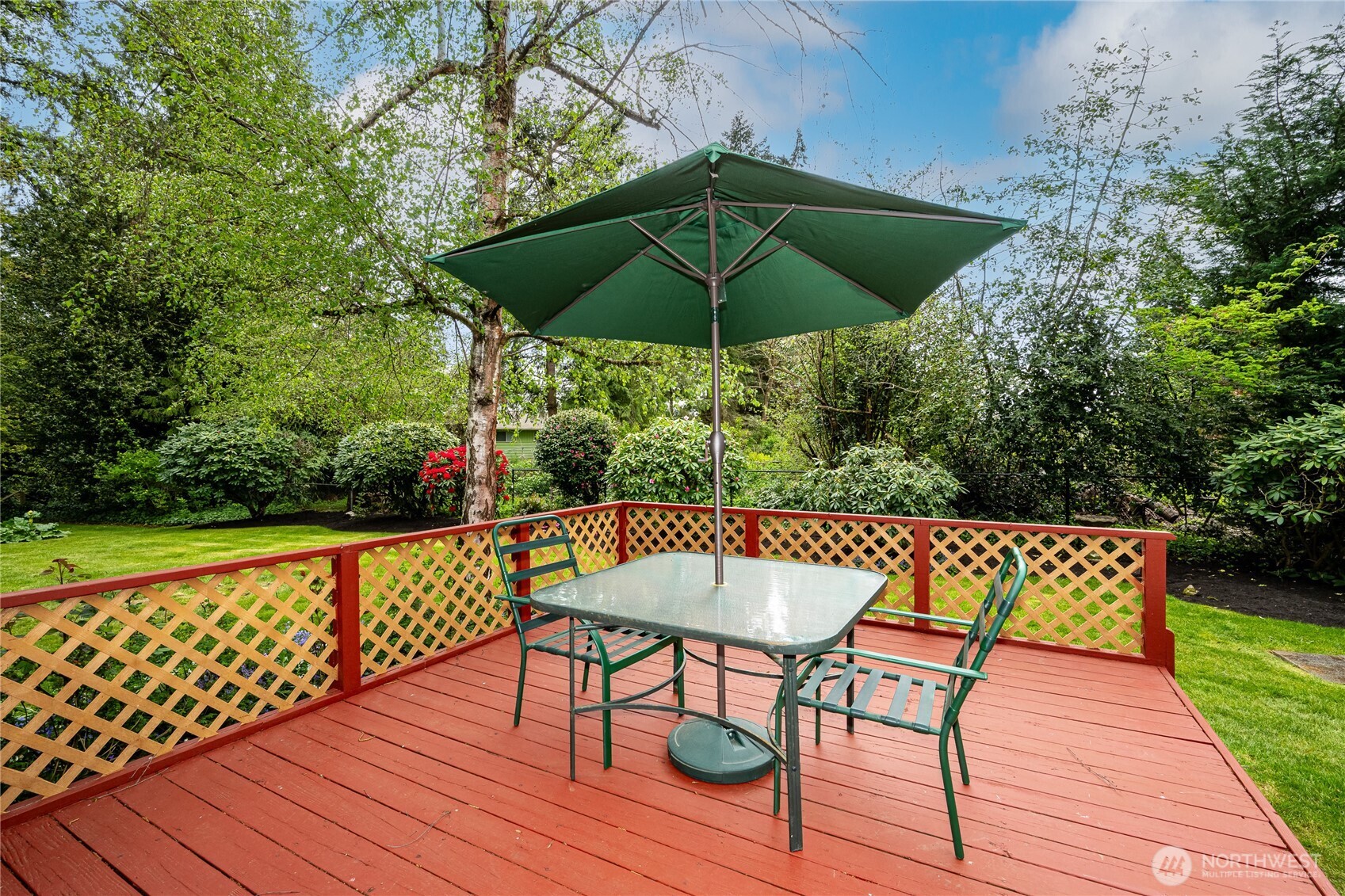 Peaceful and serene, the deck off the Family Room is the perfect place to enjoy your morning coffee or dinner al fresco while admiring stunning flowering trees, shrubbery and bulbs that bloom every year!