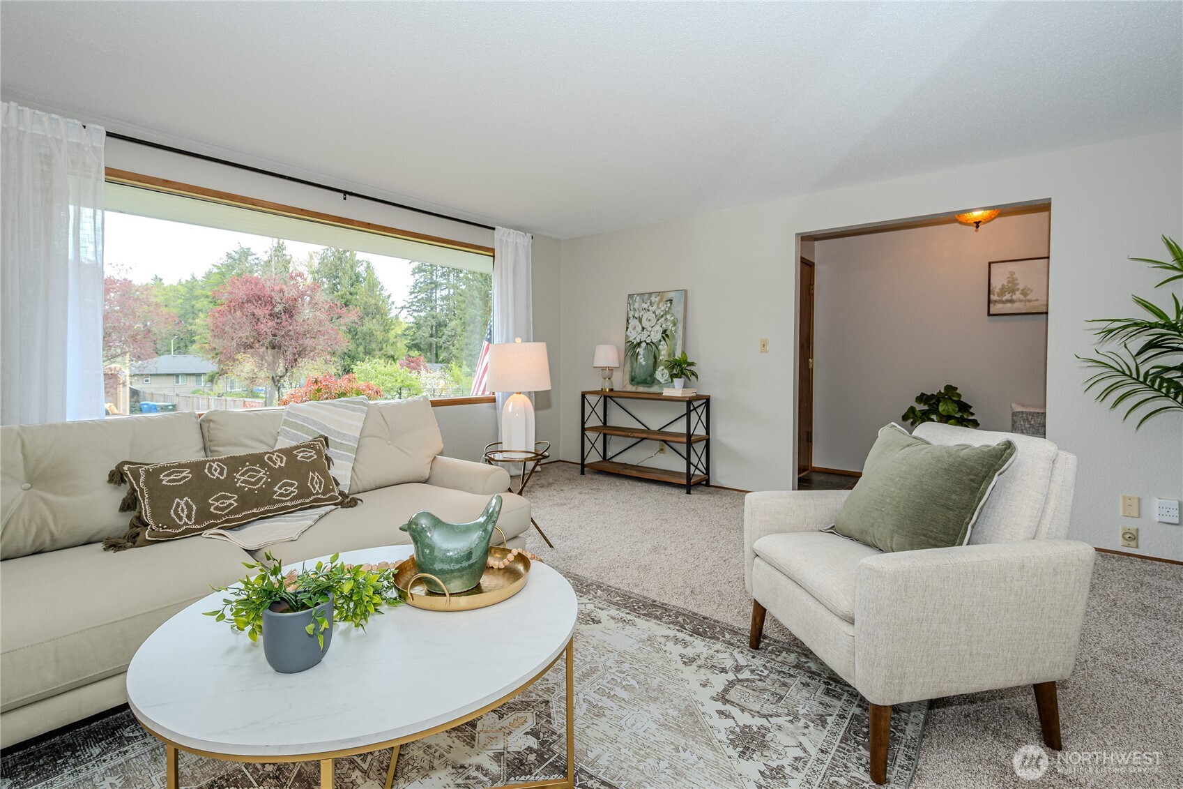 Looking through the Living Room window to pretty front yard views and into the entry