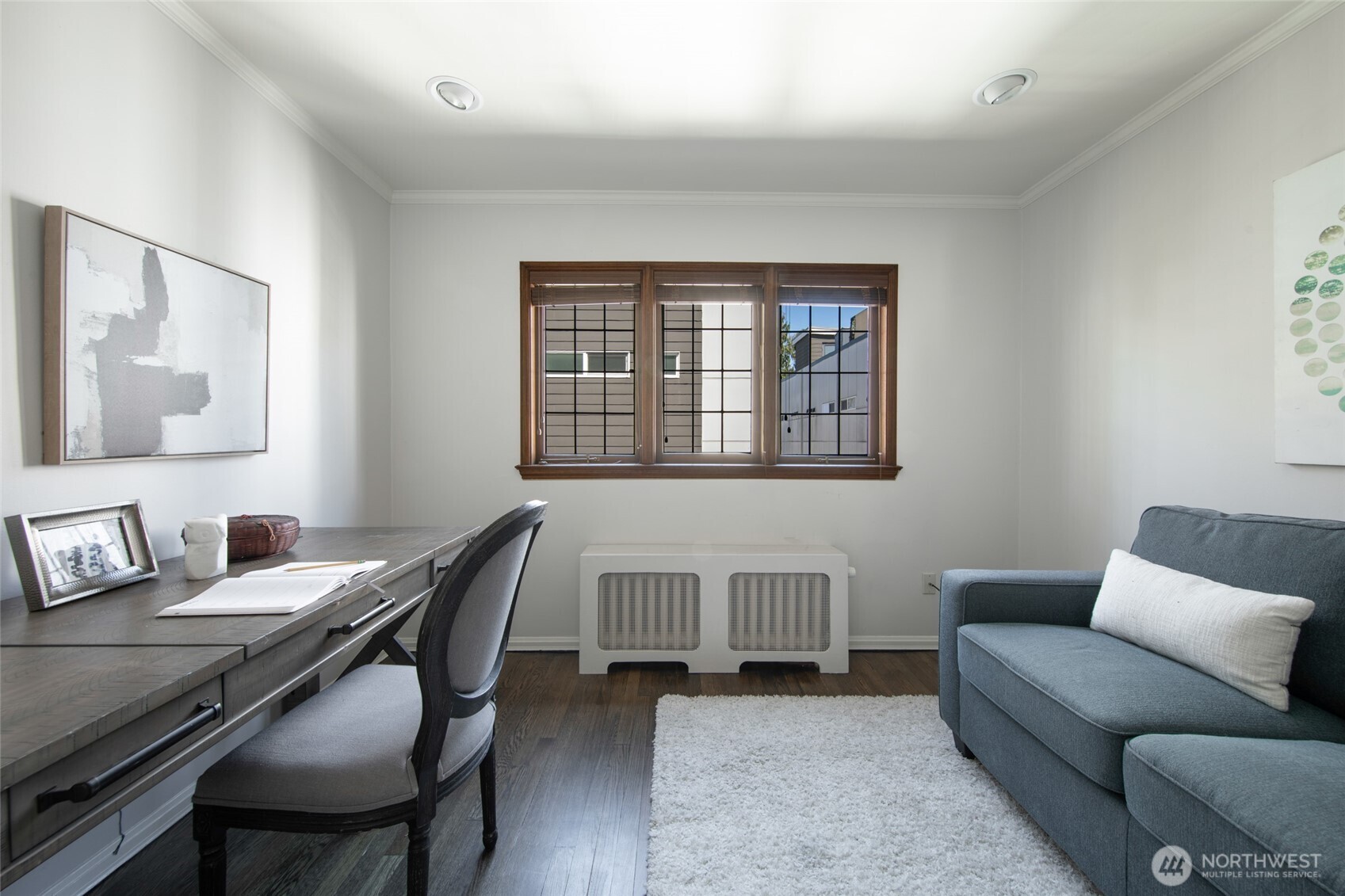 This second bedroom can double as an office or den and features refinished hardwoods and lead glass windows.