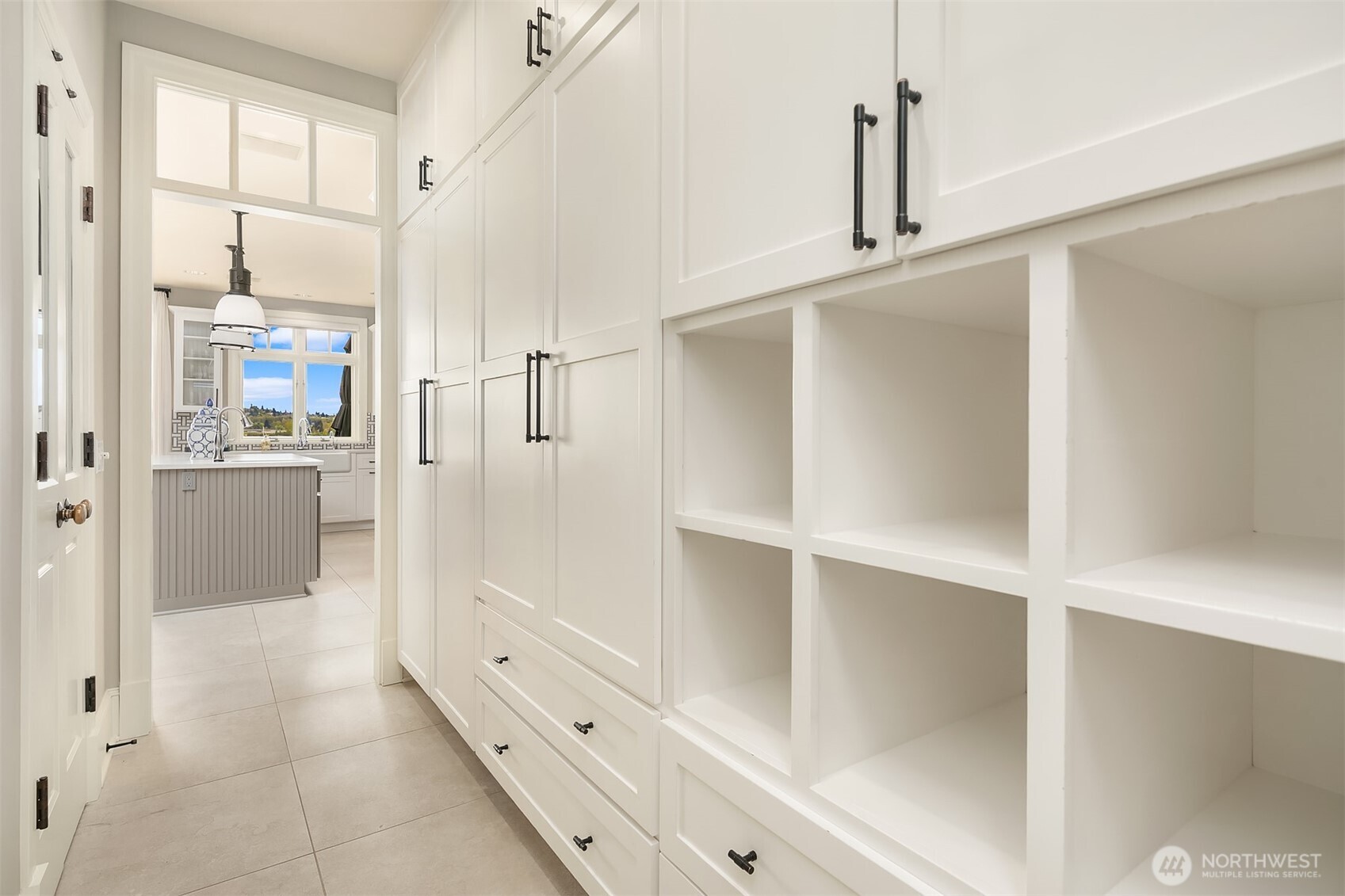 Enviable mud room with ample storage is adjacent to garage entrance.  Spacious walk-in pantry located on the left before kitchen.