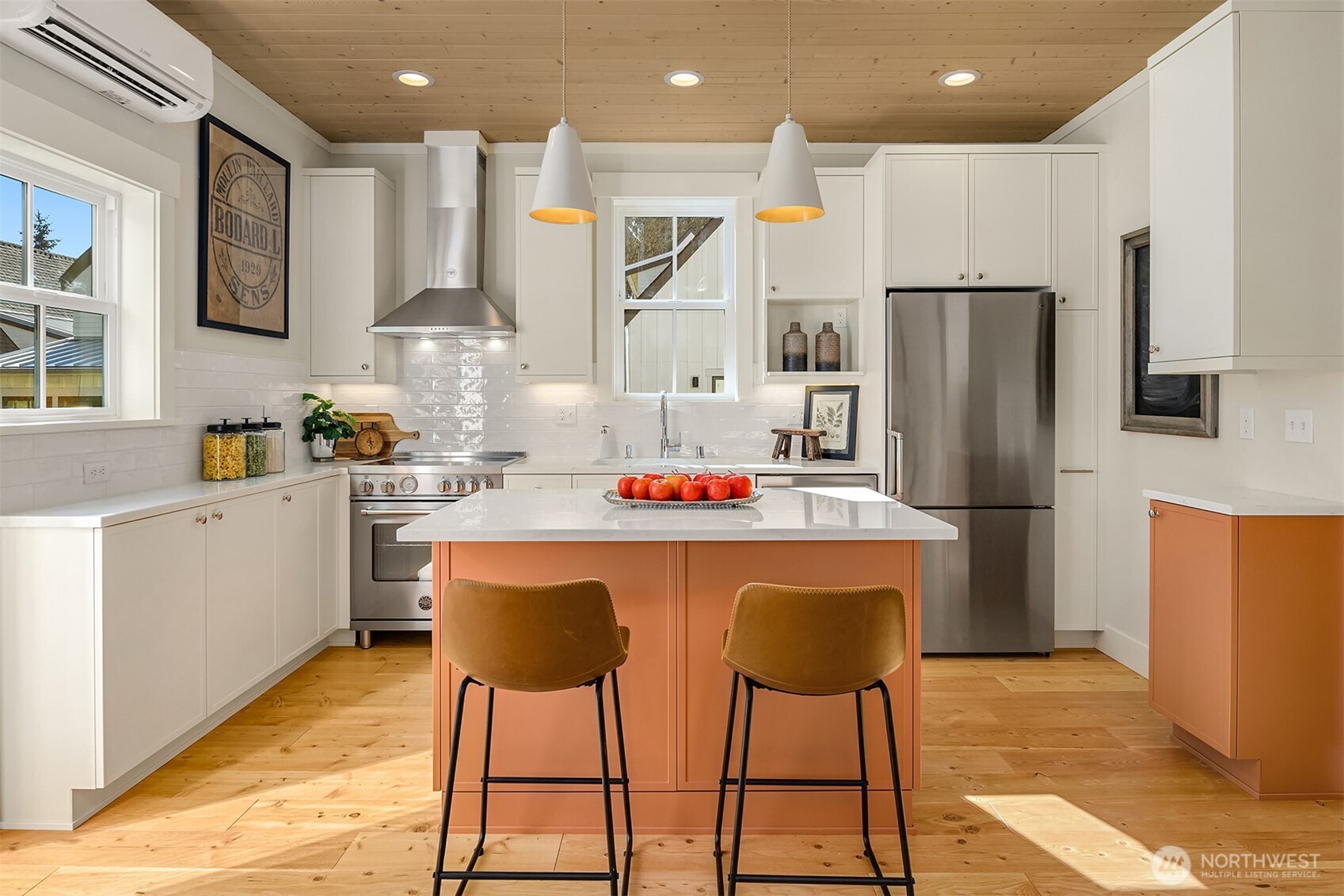 Efficient kitchen features Bertazzoni induction cooking, 600 CFM hood, refrigerator and Bosch dishwasher. Custom Bellmont painted cabinetry with pull out pantry cabinet.