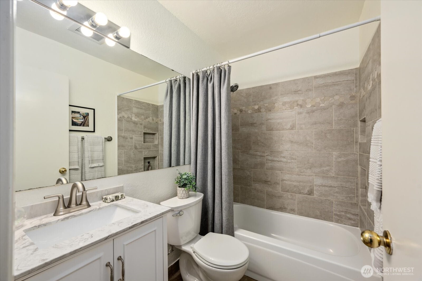 Guest bathroom with updated vanity and tiling!