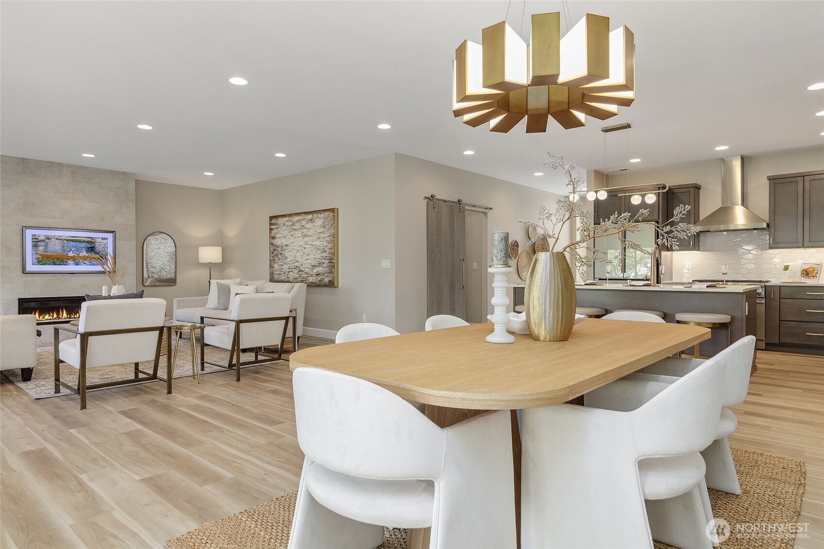 The ease of entertaining extends effortlessly from the kitchen to the adjacent dining and living rooms, creating a cohesive and welcoming space for gatherings of any size.