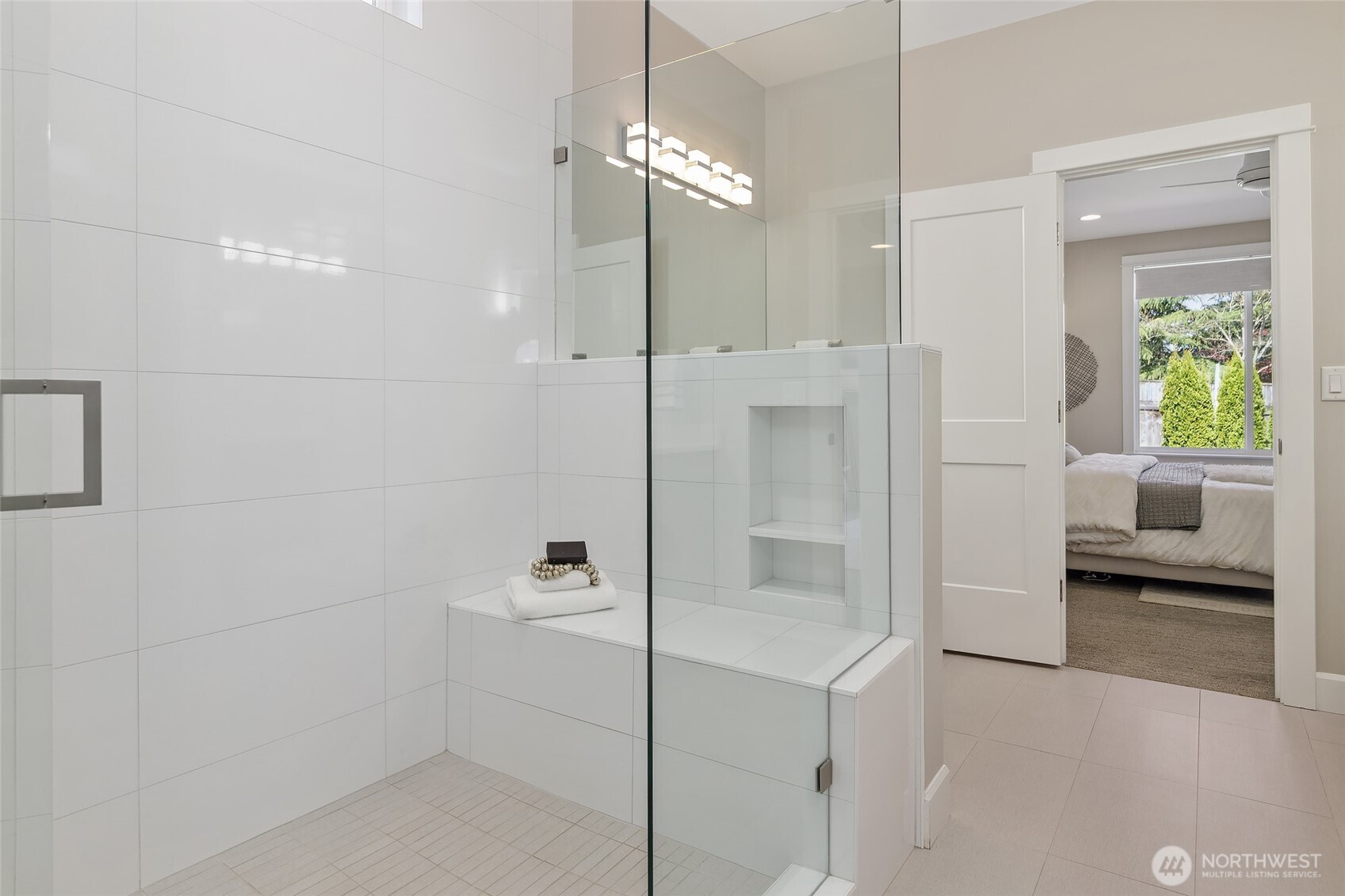 A standout feature of the ensuite bath is the generously sized walk-in shower, complete with comfortable bench seating.